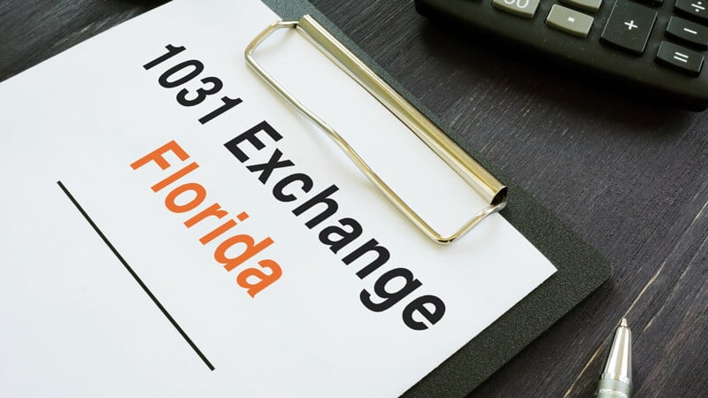 A clipboard with a piece of paper that says 1031 Exchange Florida.