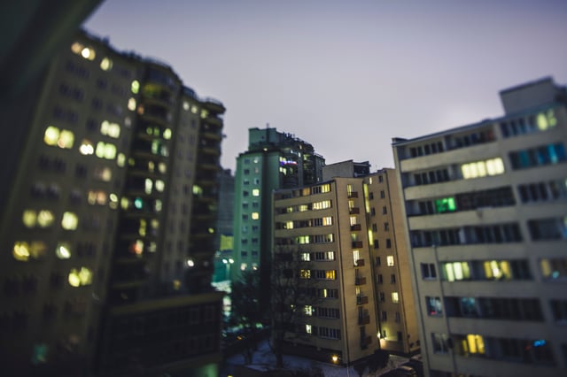 A nighttime view of a city populated by high rises, some of which have a Tenants-in-Common structure, while others owned/operated through a Delaware Statutory Trust. 