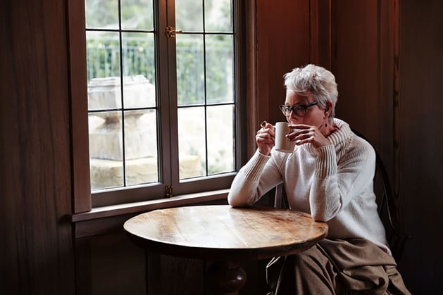 A woman drinking coffee trying to figure out if she qualifies for a 1031 exchange.