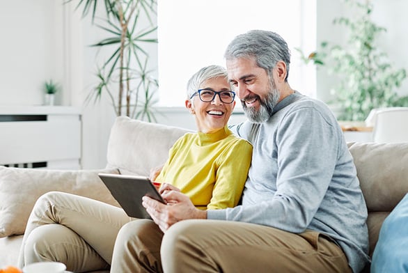 couple-smiling-tablet-IS-1206058941