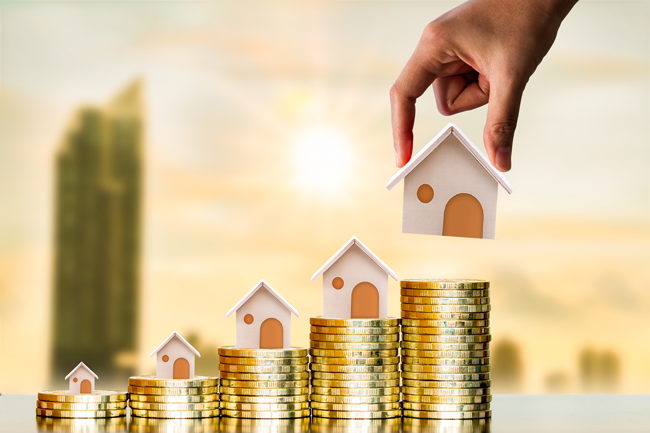 houses-stacking-on-coins-capital-gains-AS-269739065