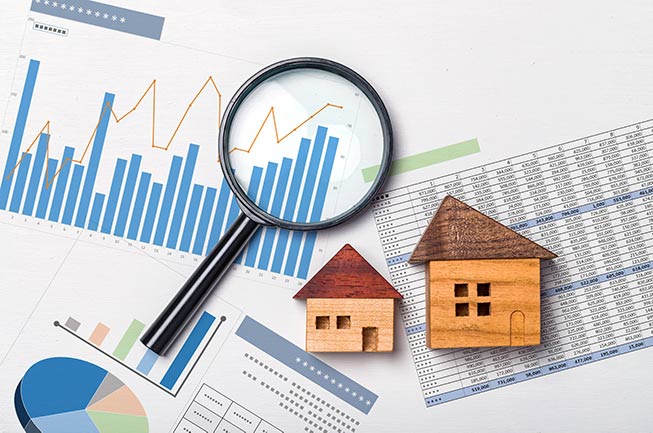 magnifying-glass-bar-chart-houses-IS-1186618062