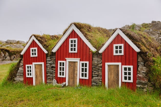 An image of three old-fashioned houses, that represent the long history of 1031 exchanges.