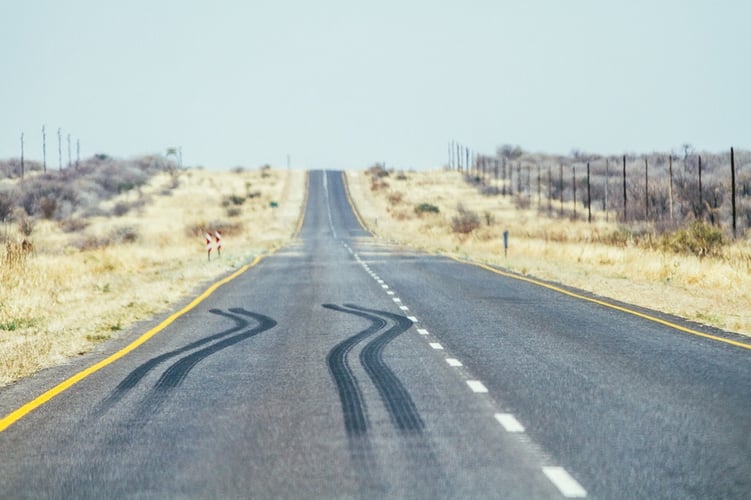 An empty road stretches out, with a clear set of skid marks, signifying the abrupt stop that will happen to your 1031 exchange when your qualified intermediary goes bankrupt. 
