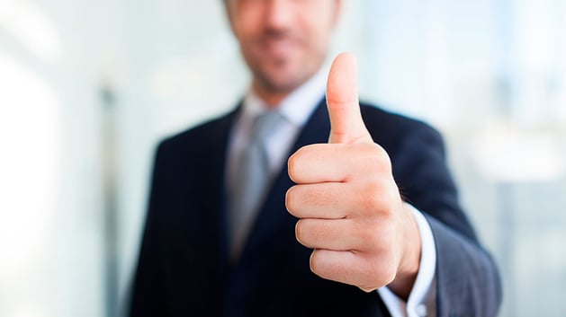 Business man giving the thumbs up on tax benefits of real estate investing