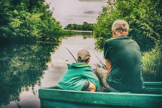 Grandparent fishing with grandson