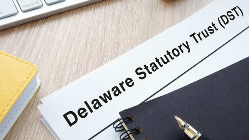 Paper with the words Delaware Statutory Trust (DST) on it.