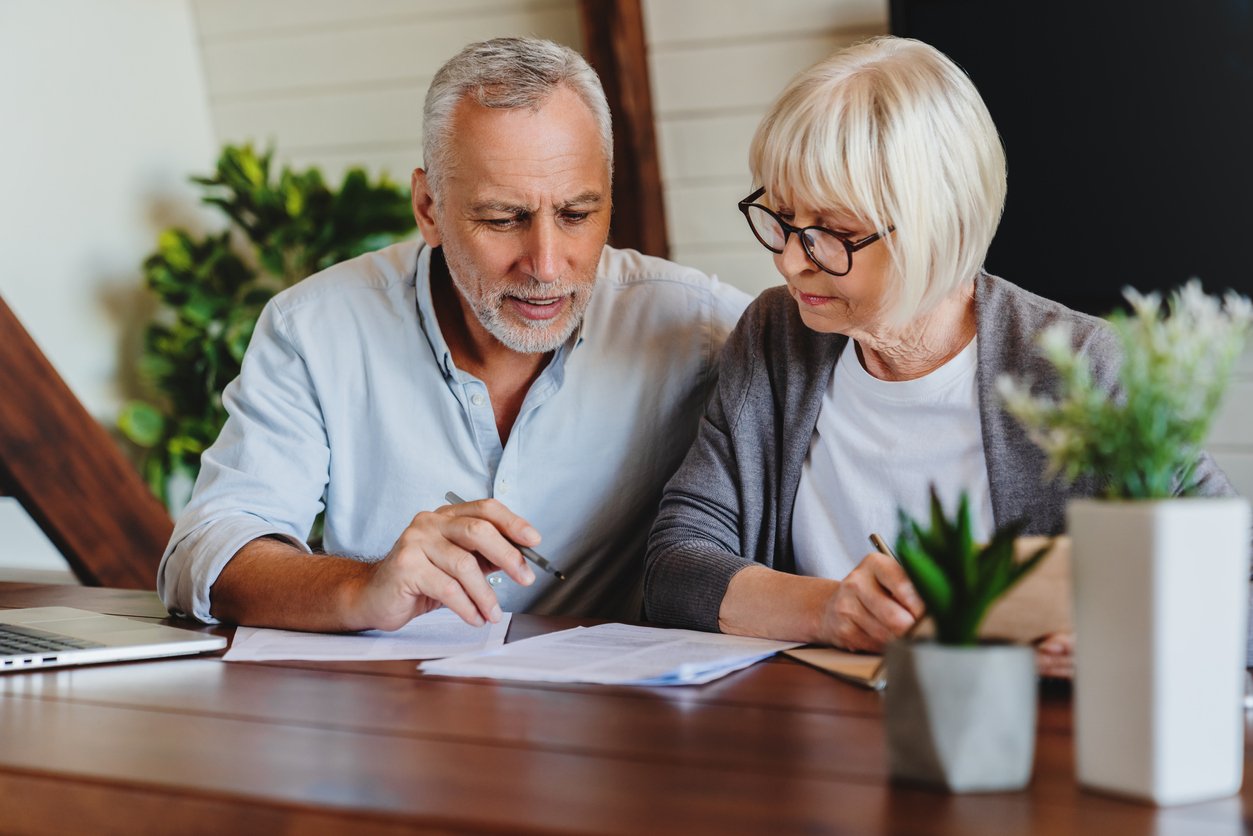 A picture of a couple reviewing their tenancy by the entirety contract.