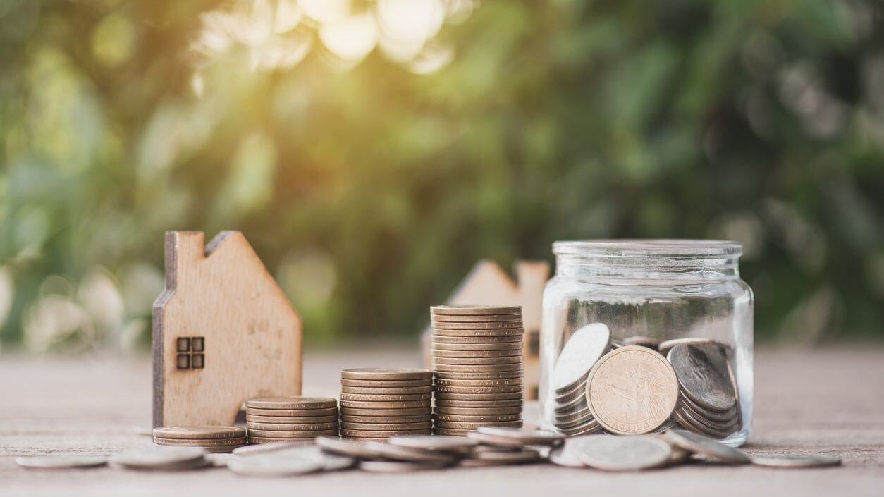 House, coins, and coins in a jar.