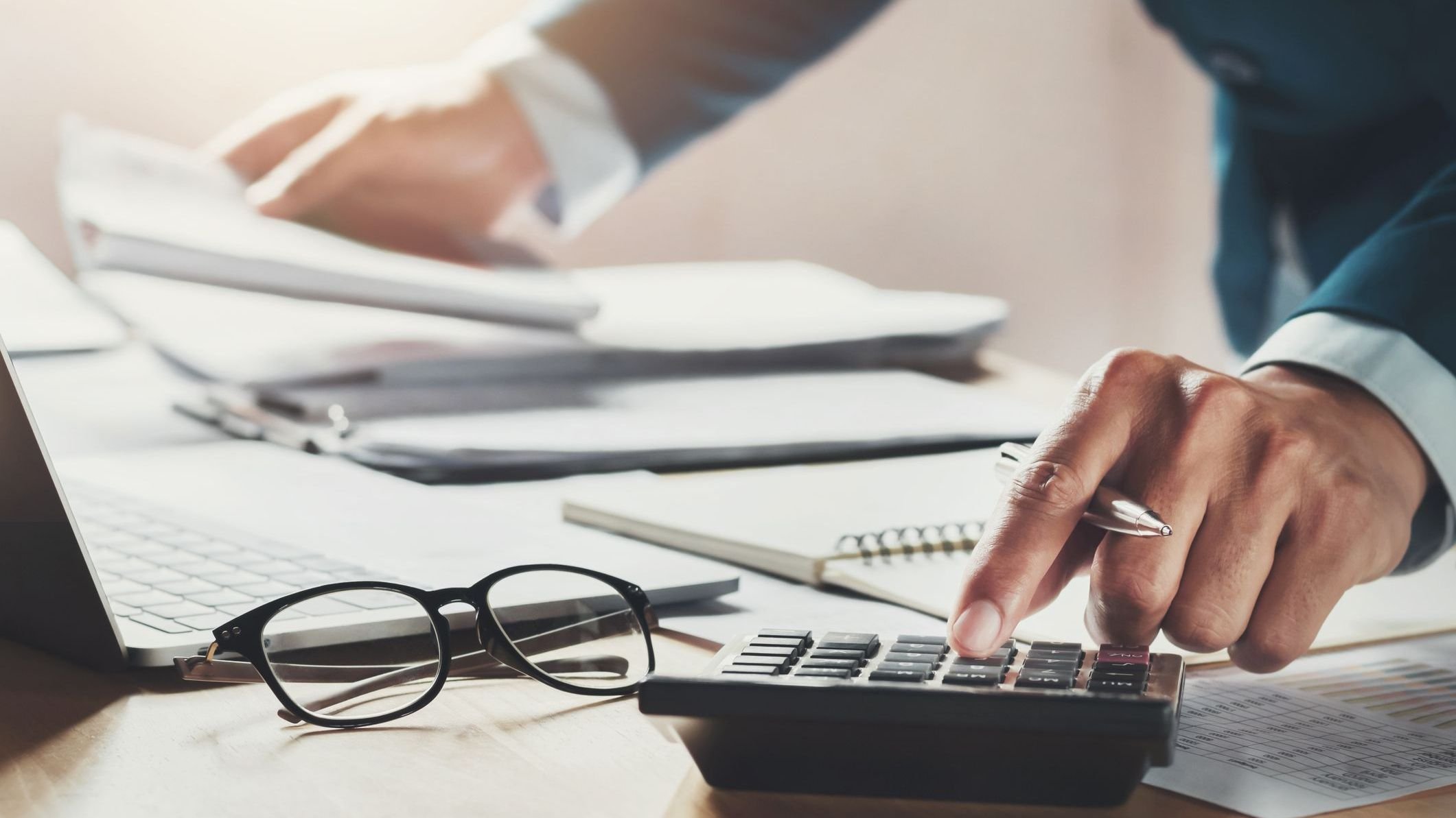 Businessman using calculator for calculate working in office.