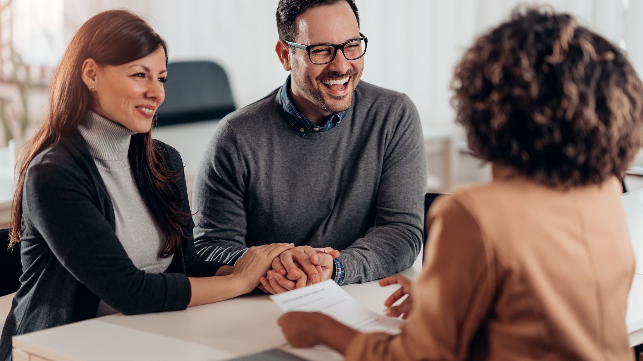 Married couple talking with financial advisor on a meeting