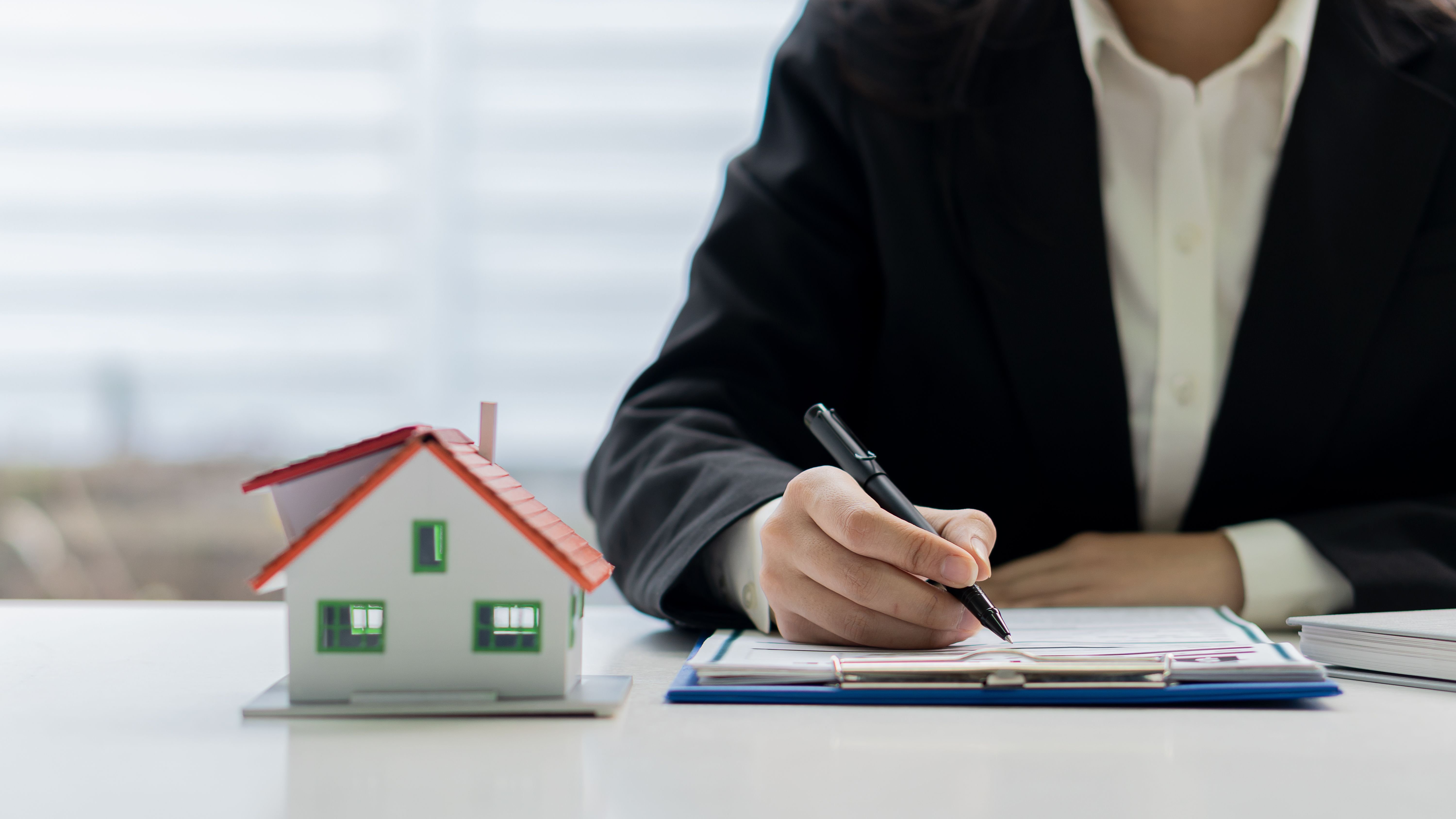 Real estate agents advise homes on renting or buying a home in an office.