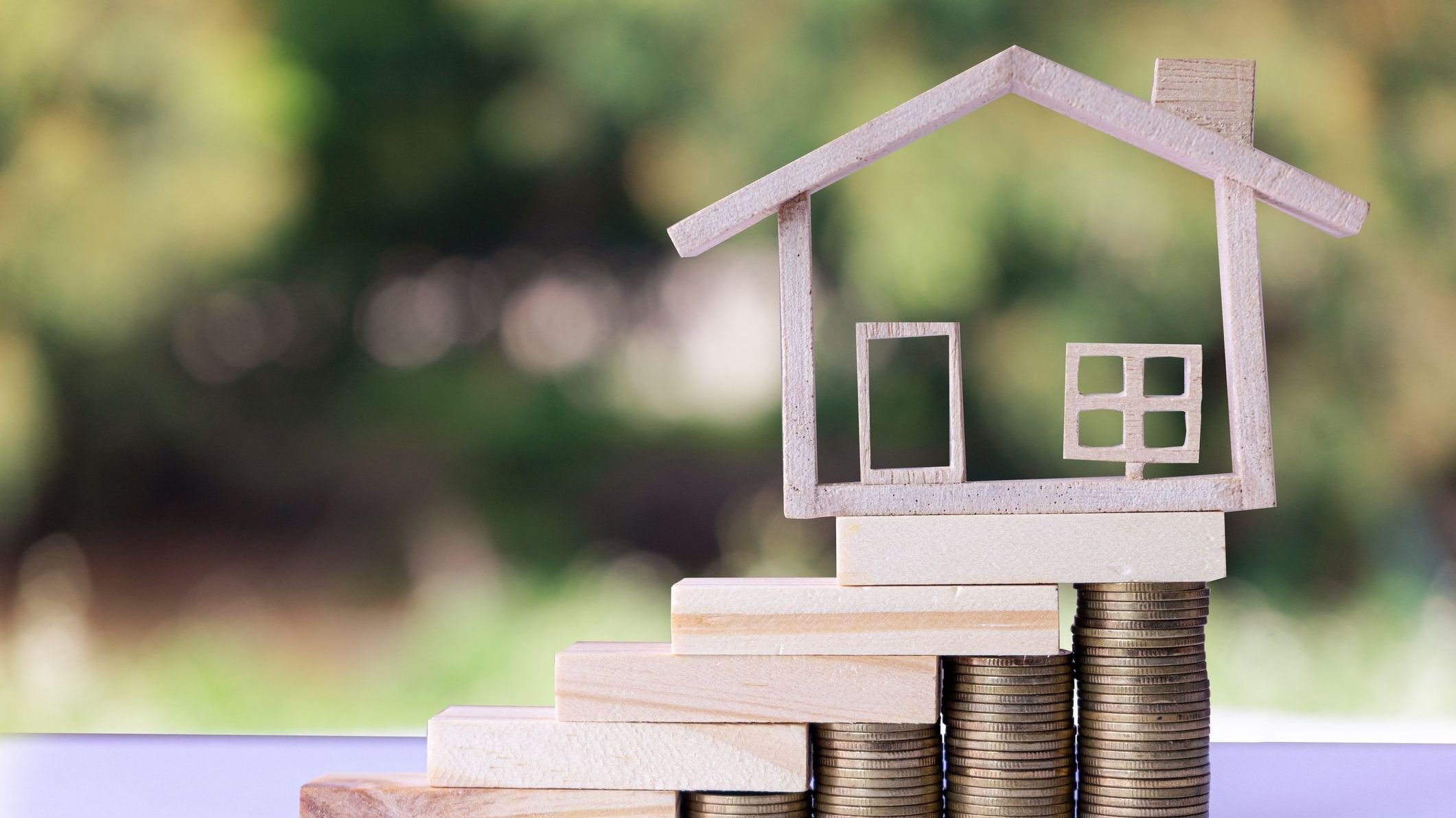 Model house on Wooden blocks stacked as stairs on stack coin money.