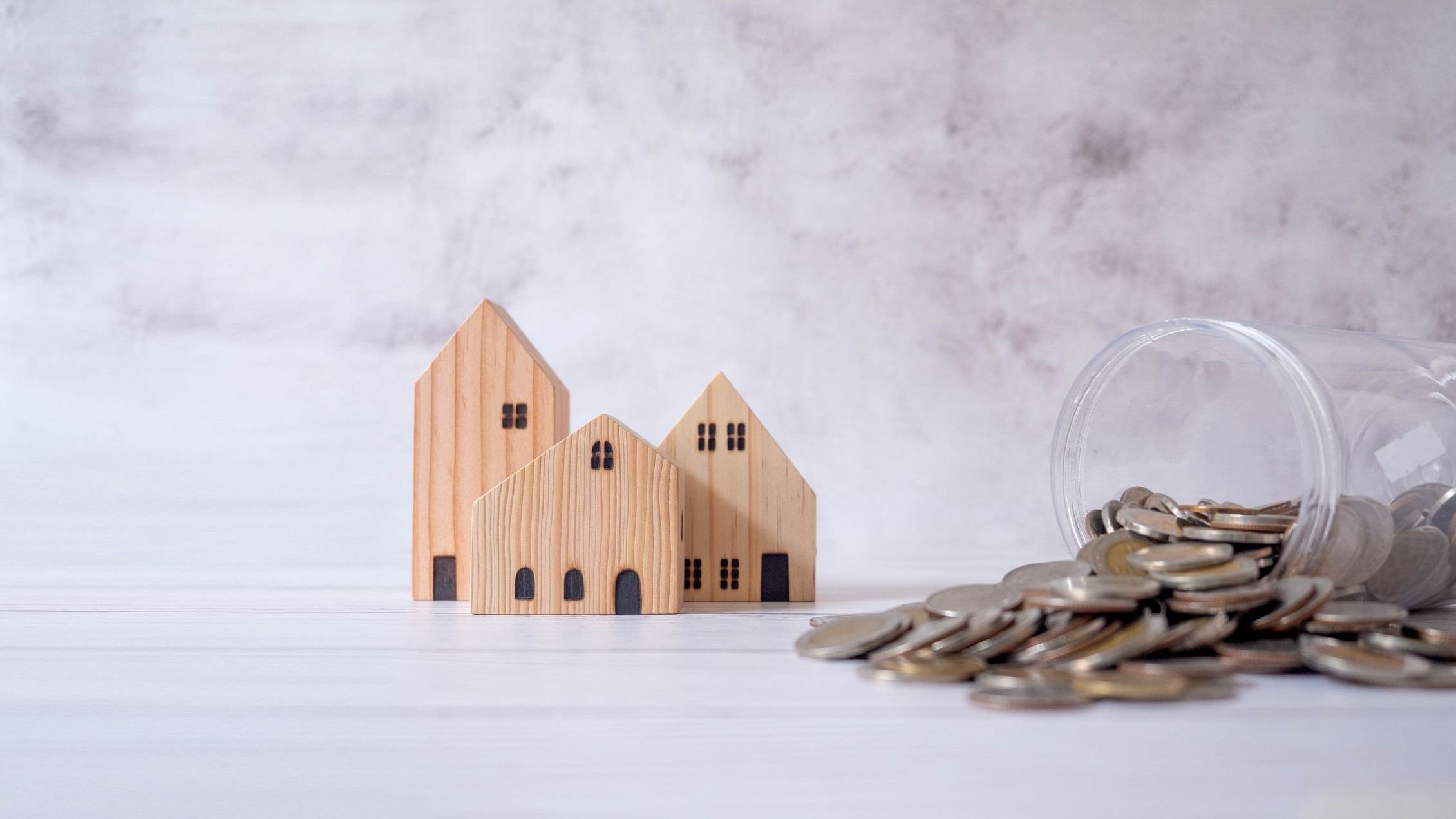 Real estate or home savings and coin piles flowing out of the jar, property investment and home mortgage financing with bank loans, money and housing savings plans