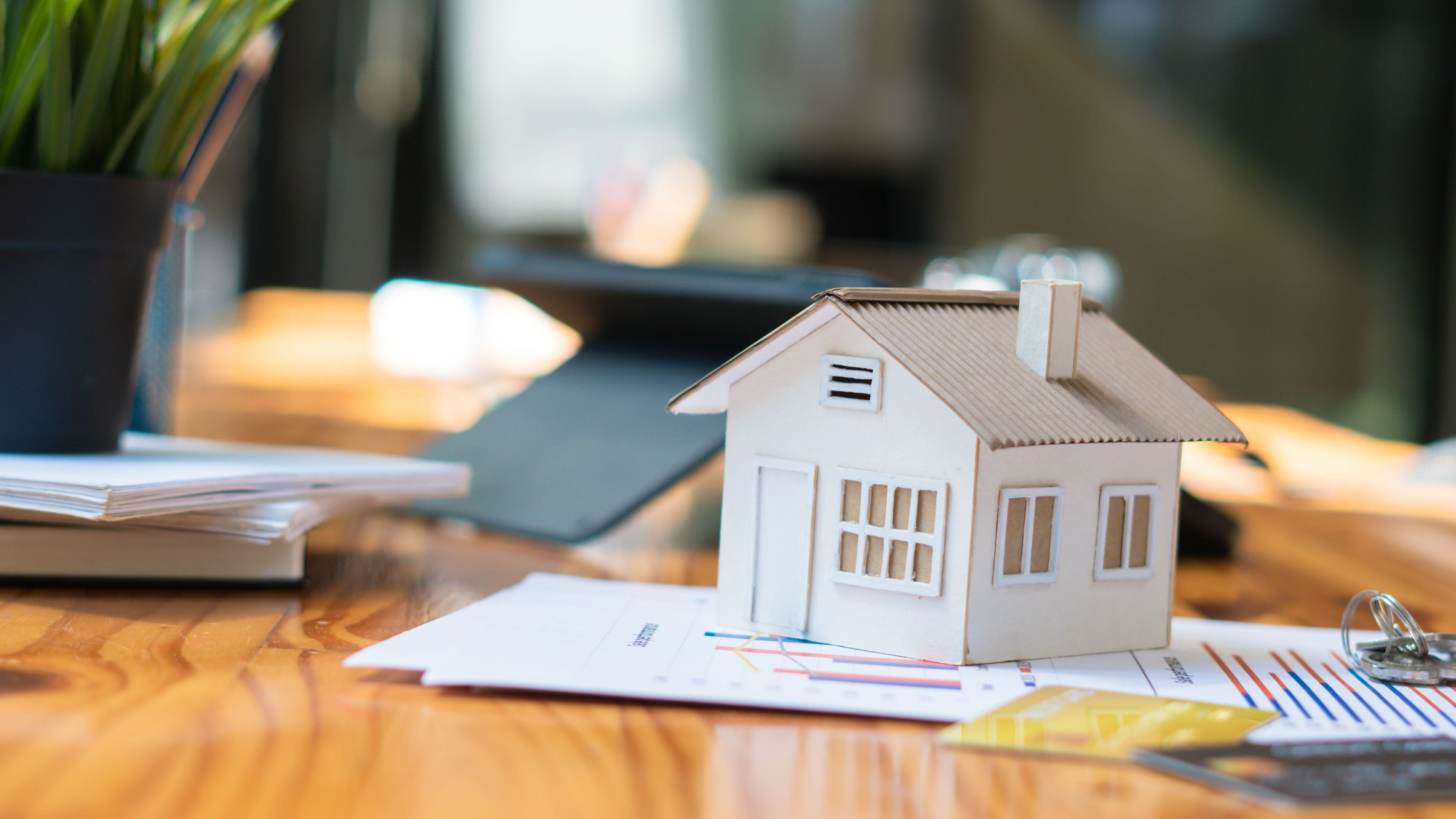 House model on sale keys on the rental agreement or the buy home contracts on wooden table