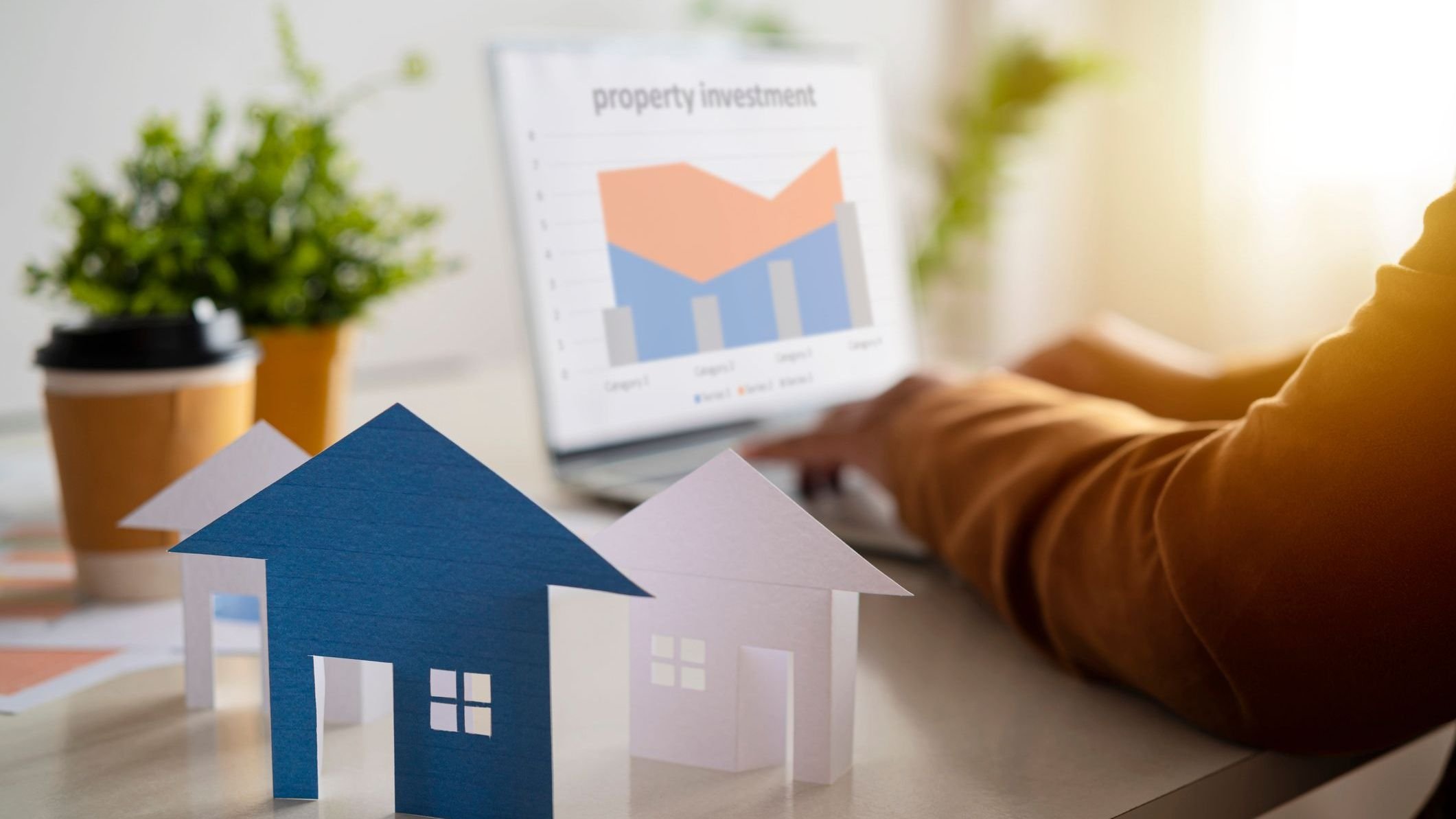 Business women are using their laptops for work and thinking about real estate investment concept