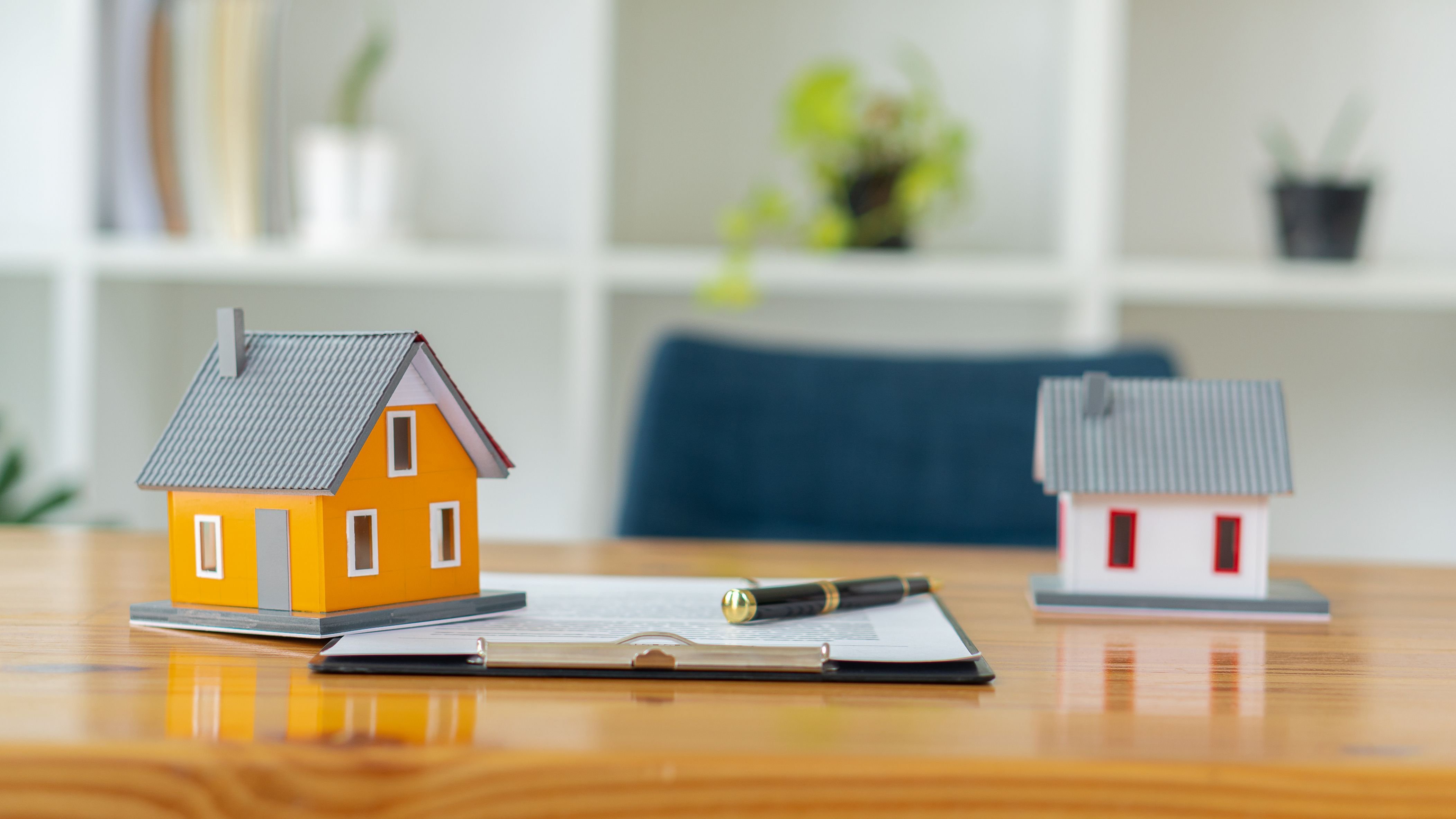 Model homes and a pen on the table.