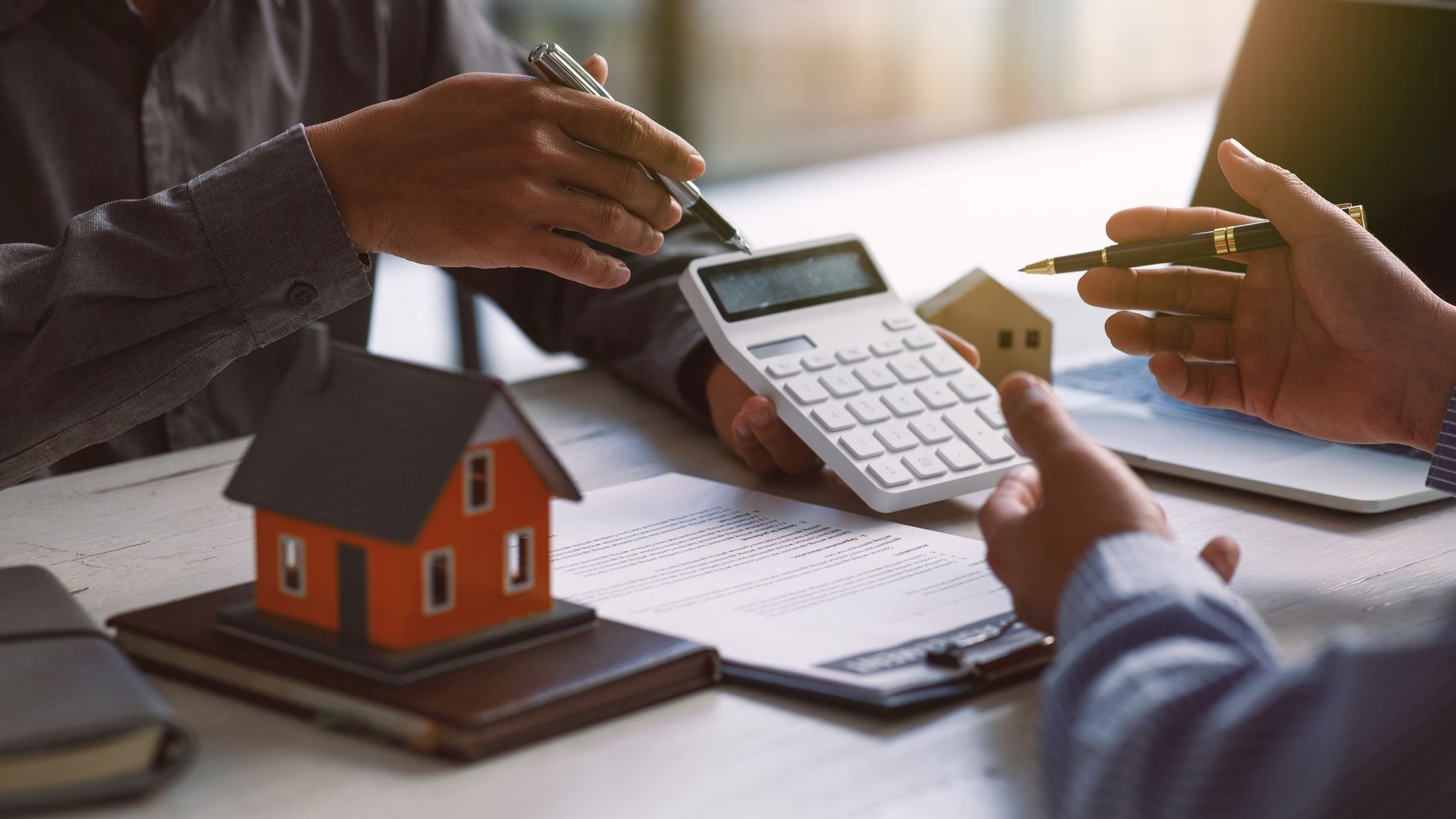 Signing contract agreement after the meeting to state organizations, Business meetings of real estate brokers and company presidents select a home model Construction concept.