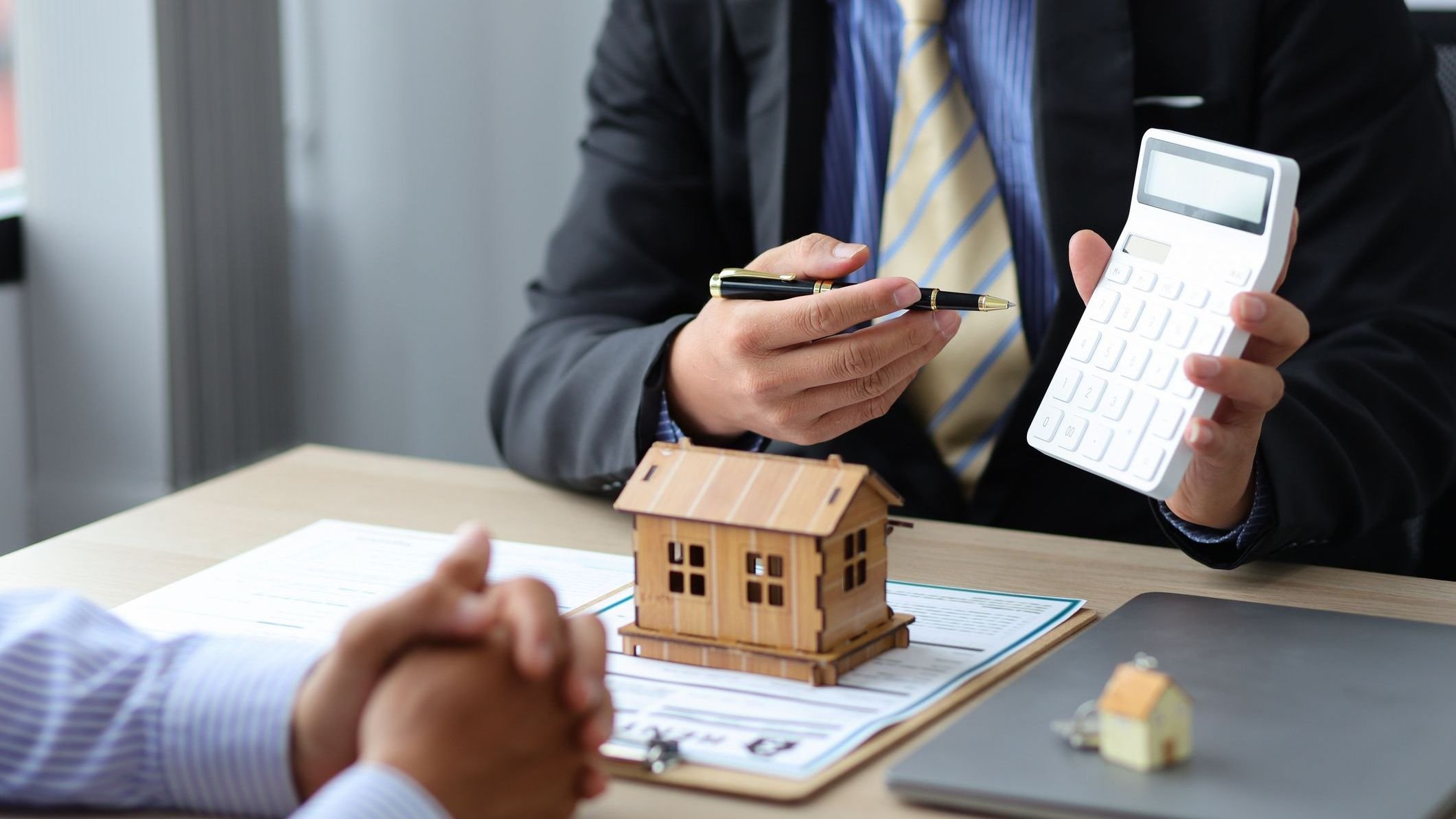Real estate agent discussing about the terms of the purchase agreement and sign the documents to make the contract legally.