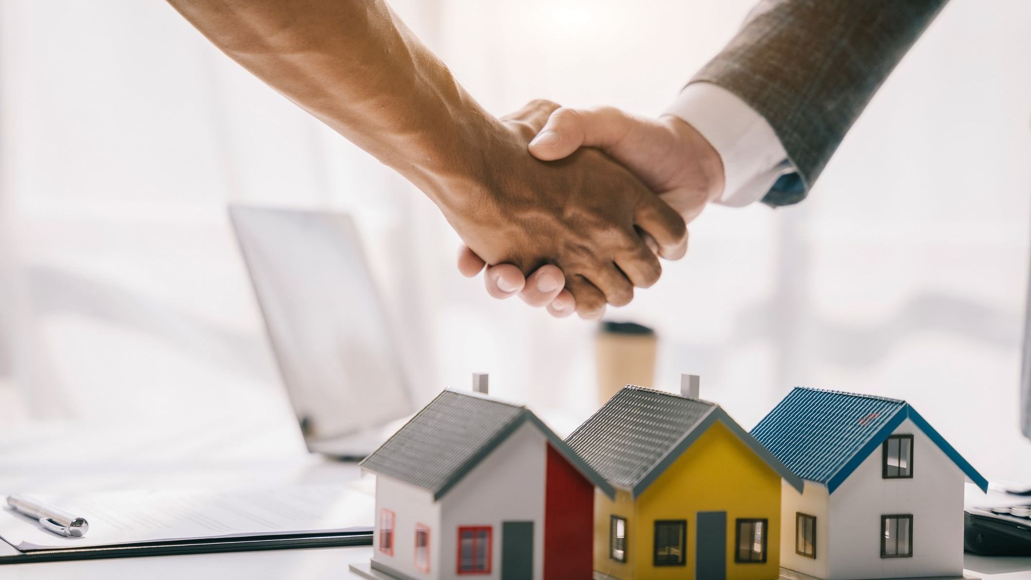 Close up shake hands, Considering buying a home, investing in real estate. Broker signs a sales agreement. agent, lease agreement, successful deal.
