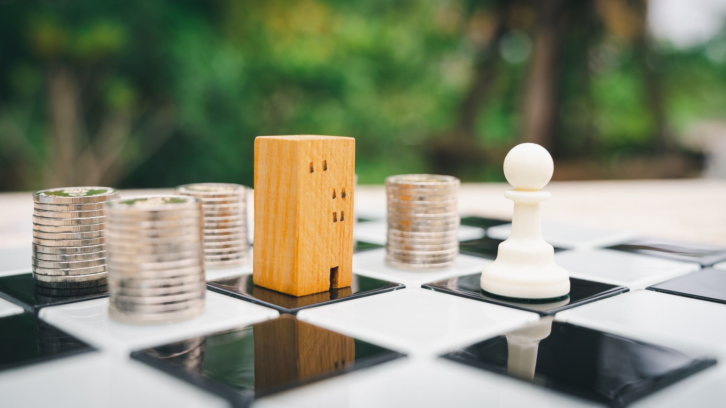 Building, coin stack and house models in chess game.
