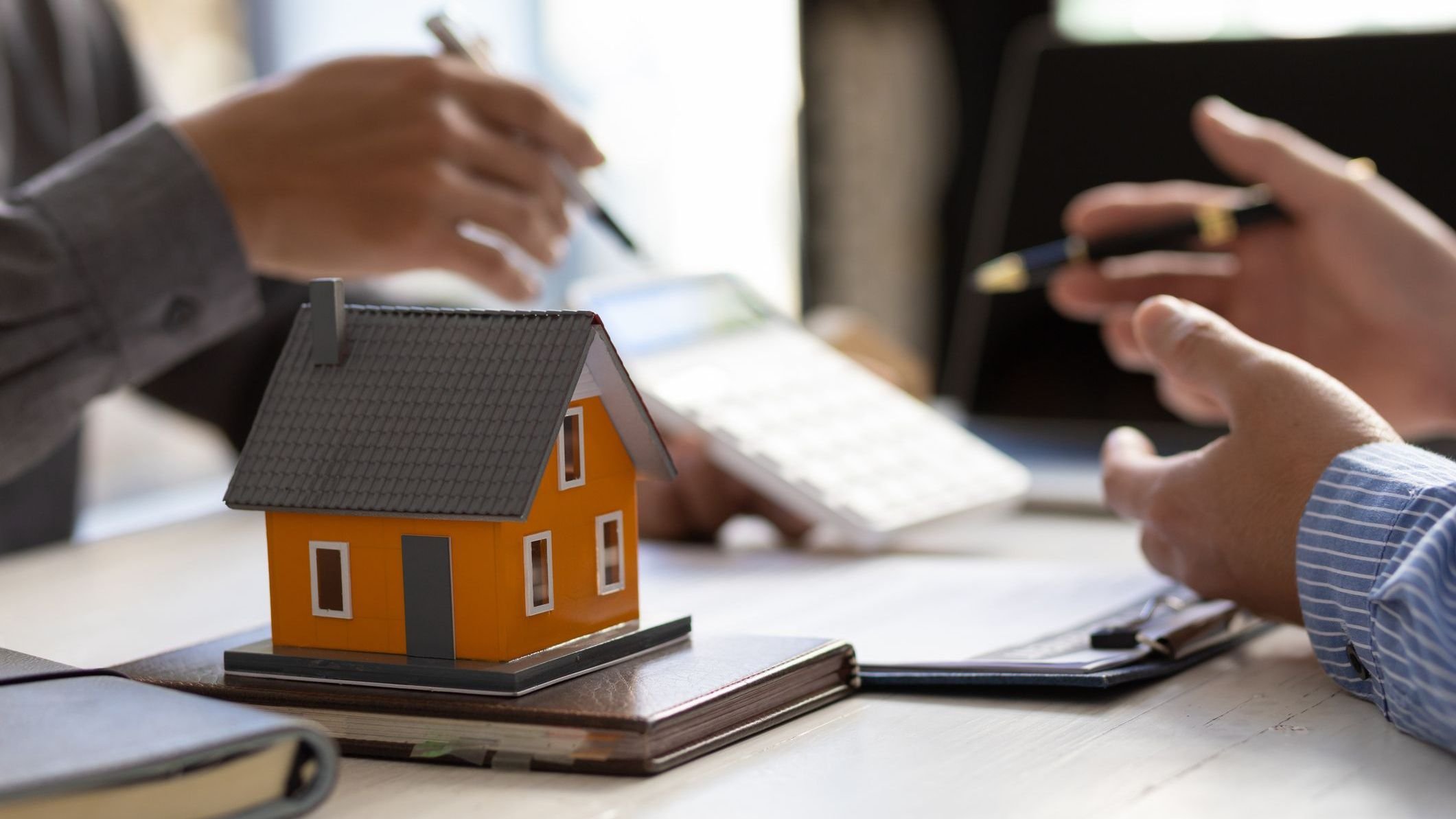 Real estate agent discuss about the terms of the home purchase agreement.