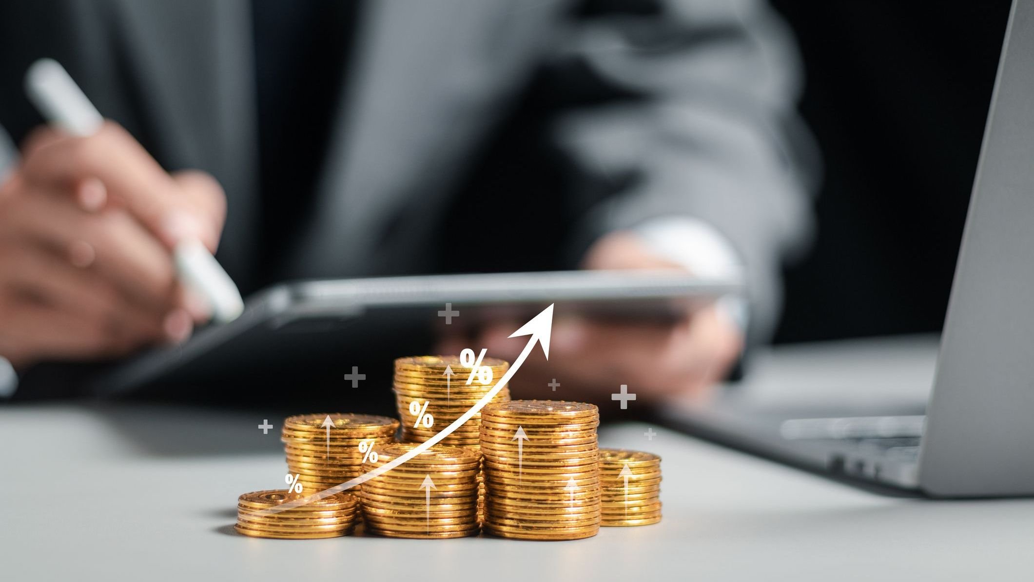 Businessman collecting coins with profit chart analysis business growth.