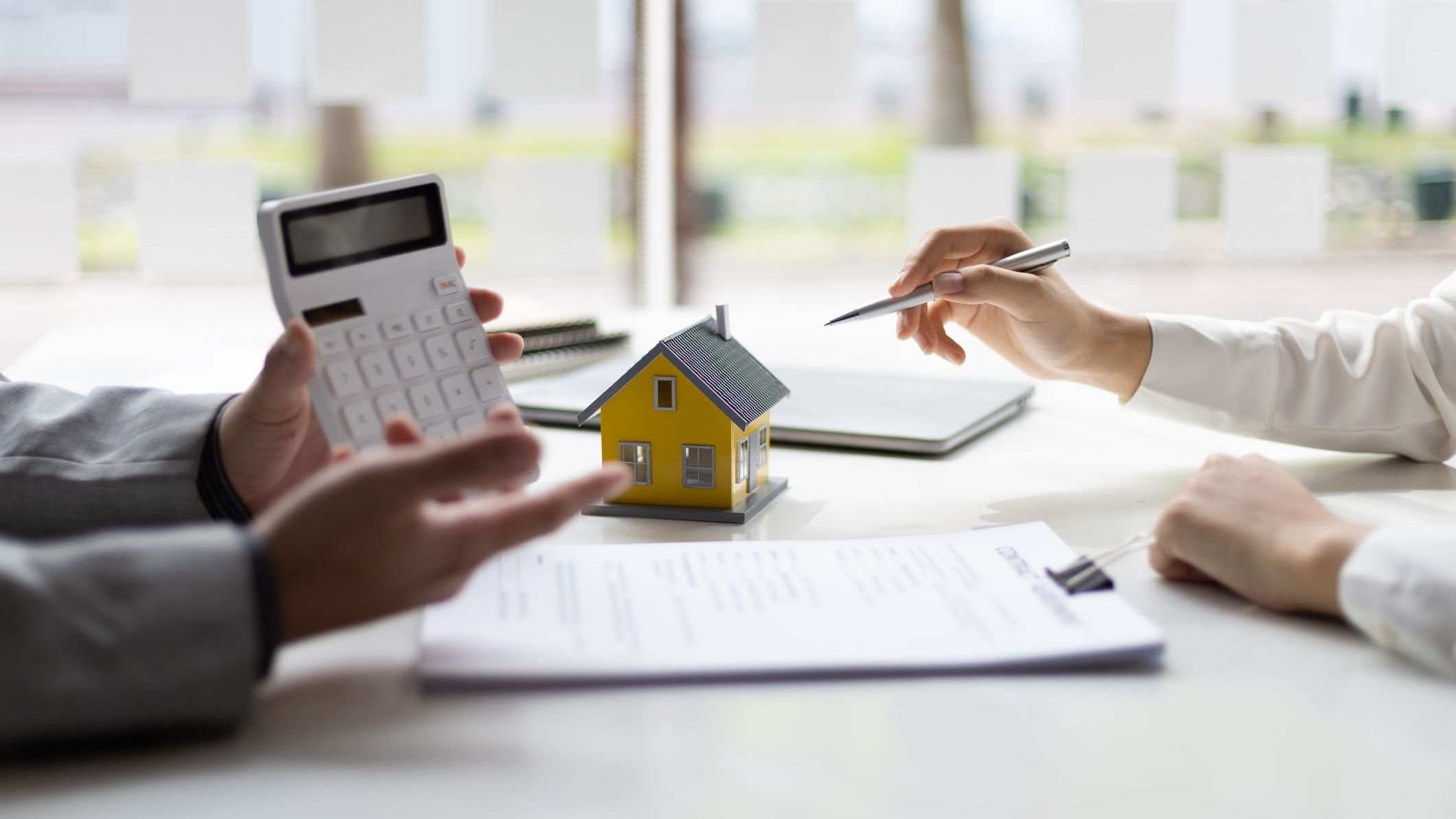 Businessmen, real estate agents discuss house purchase prices, fee, mortgage, interest, rent, cash flow, loan. Negotiate for businessmen to legally sign home purchase agreements contract , lease. 