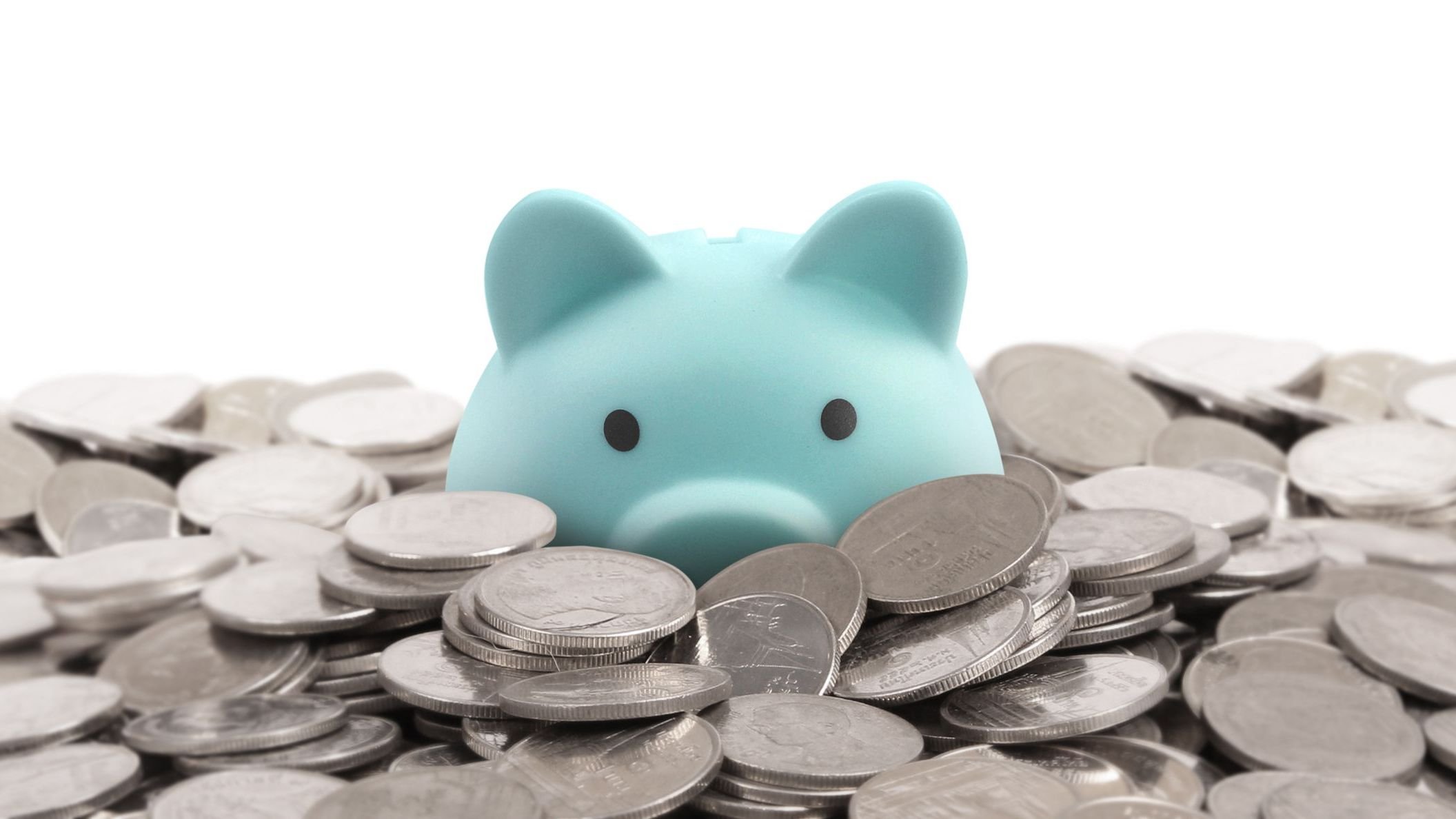 Piggy bank in a pile of coins.