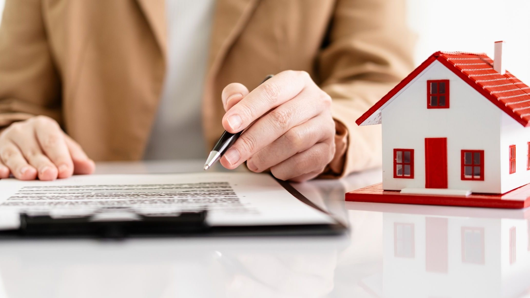 Model houses and contract documents on the desk in the office