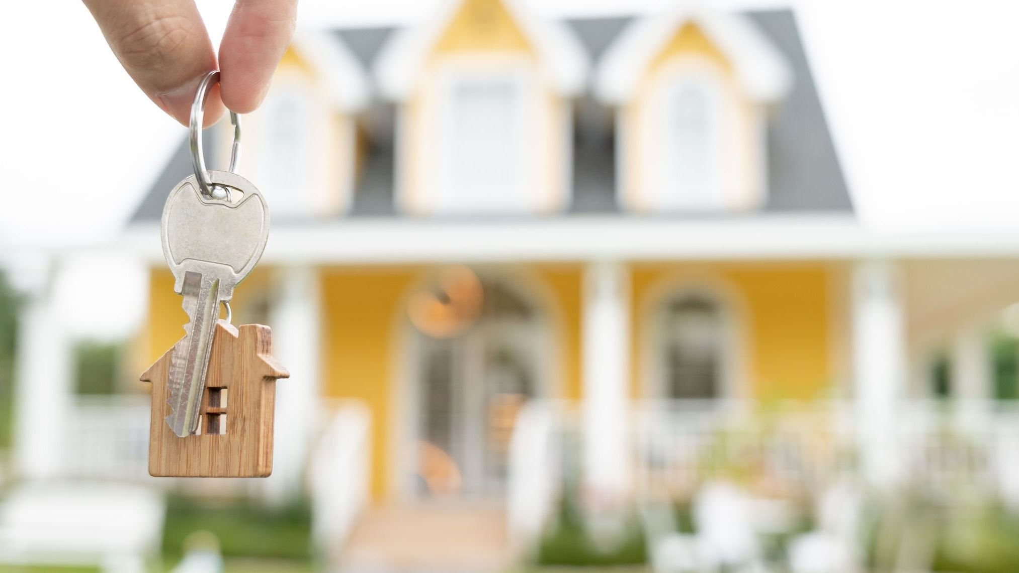 Real estate agent manager smile holding key for new owner.