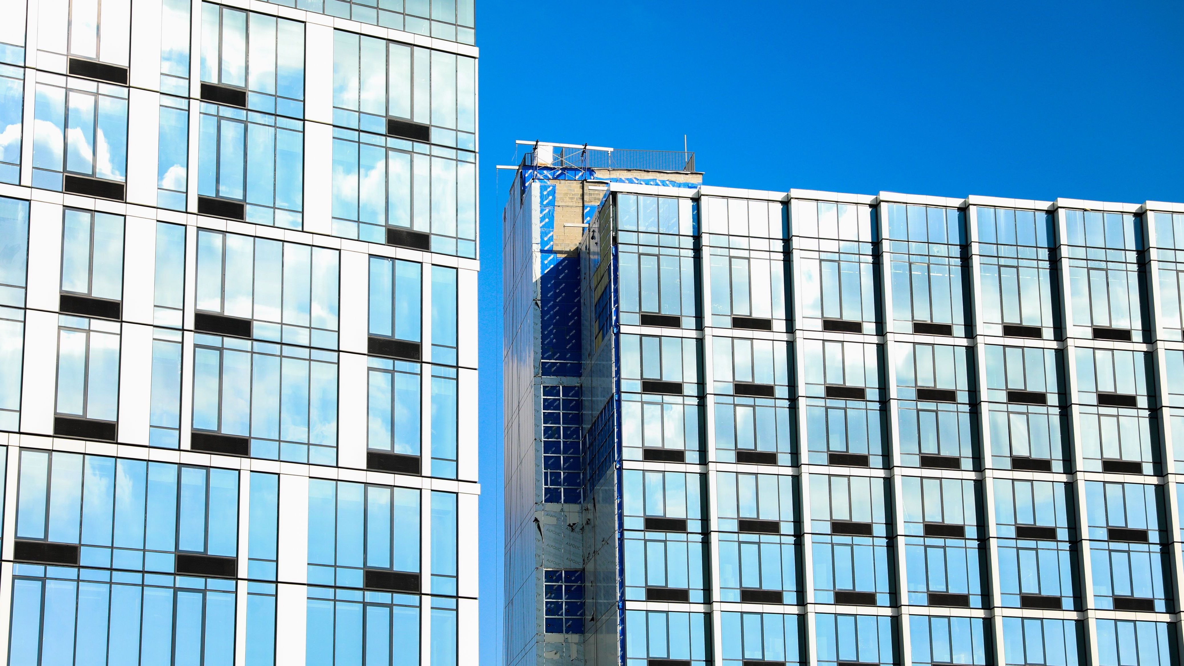 Dynamic modern cityscape with towering commercial buildings against a vibrant sky.