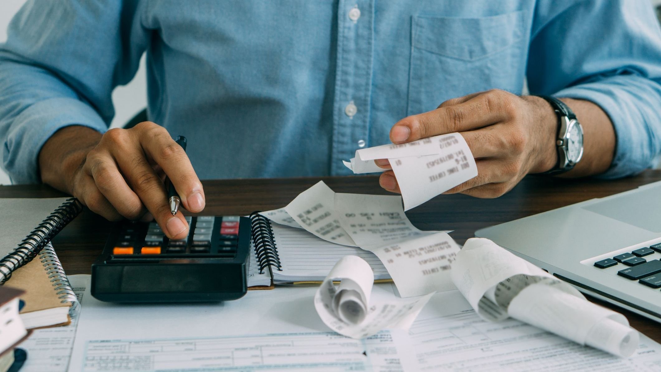 Midsection of accountant working on table.