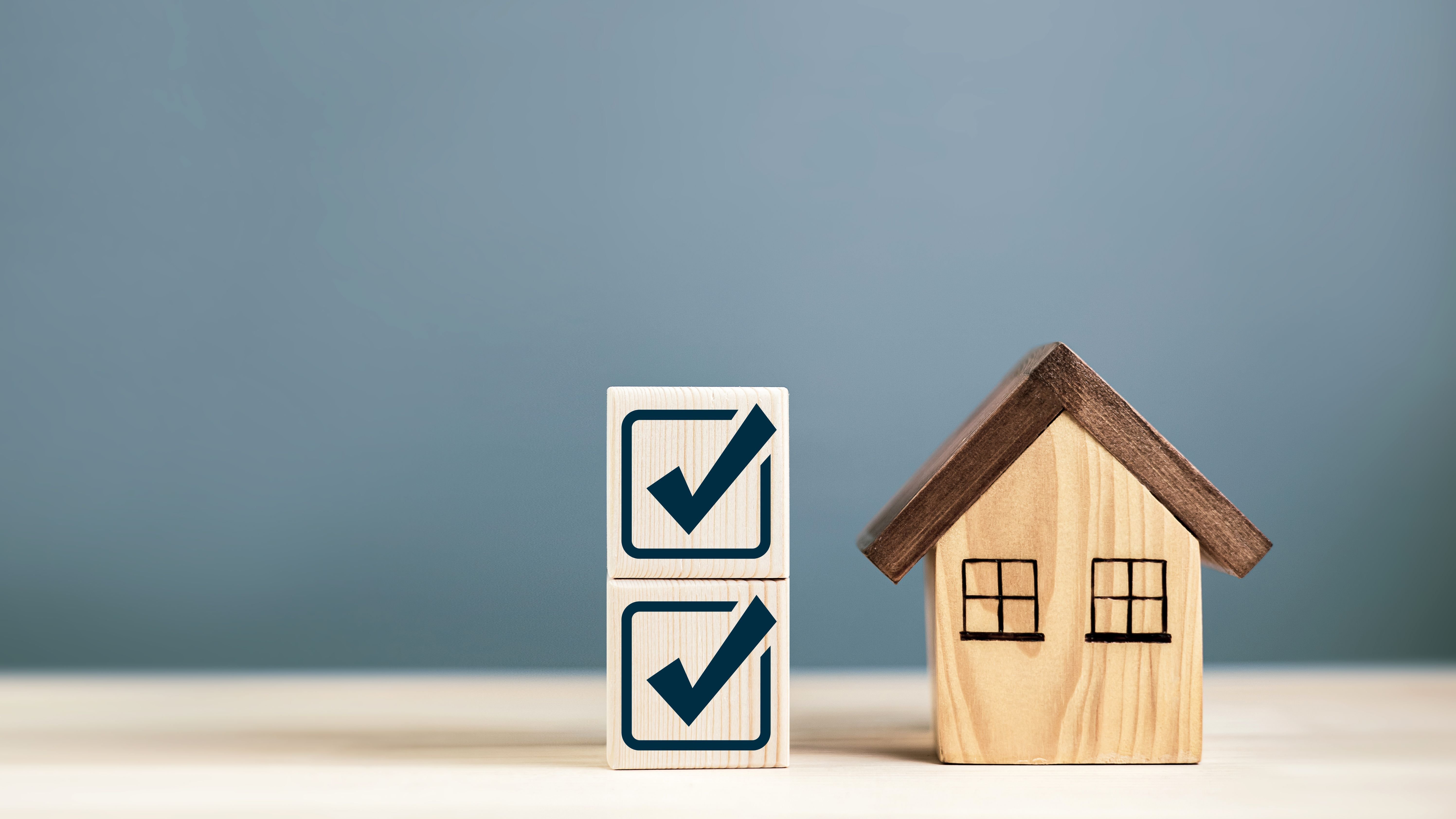 Check mark with wooden house