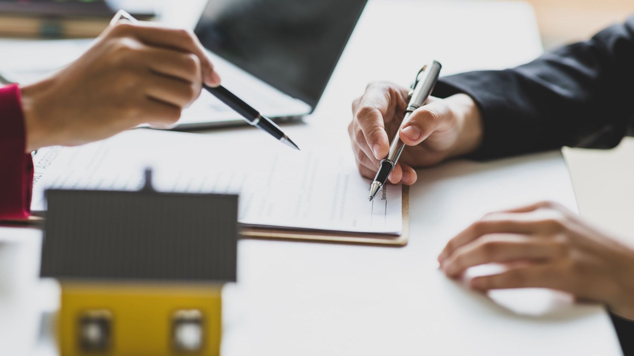 Businesswoman discusses with real estate agent, negotiates and signs contract.