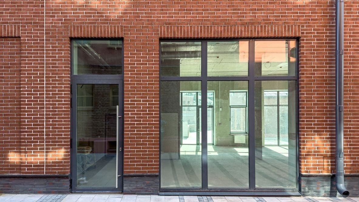 Old red brick industrial building renovated into a modern office space.