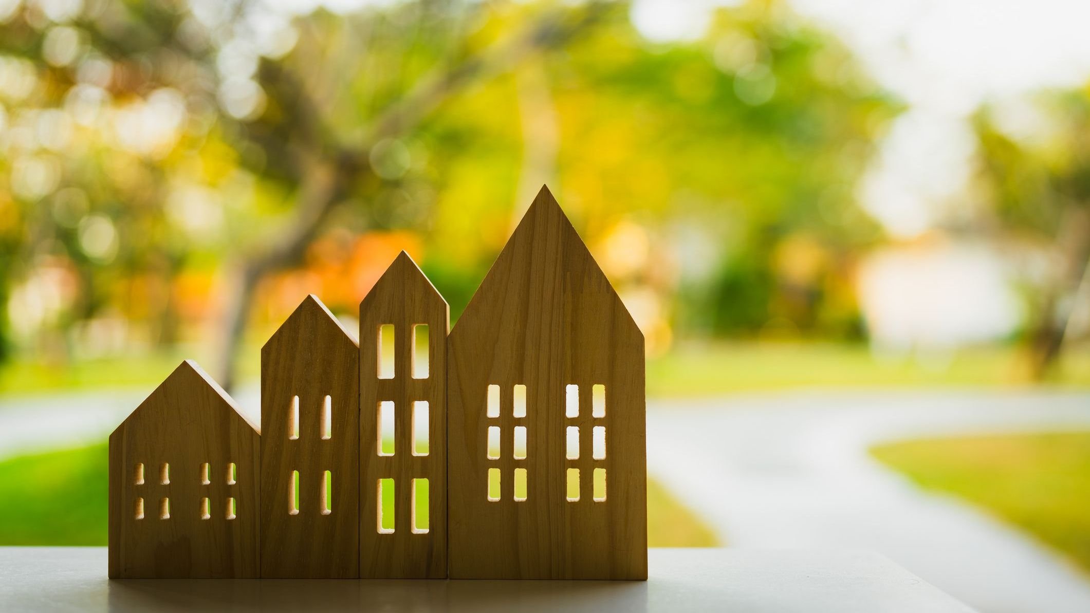 Wooden house model on wood background.