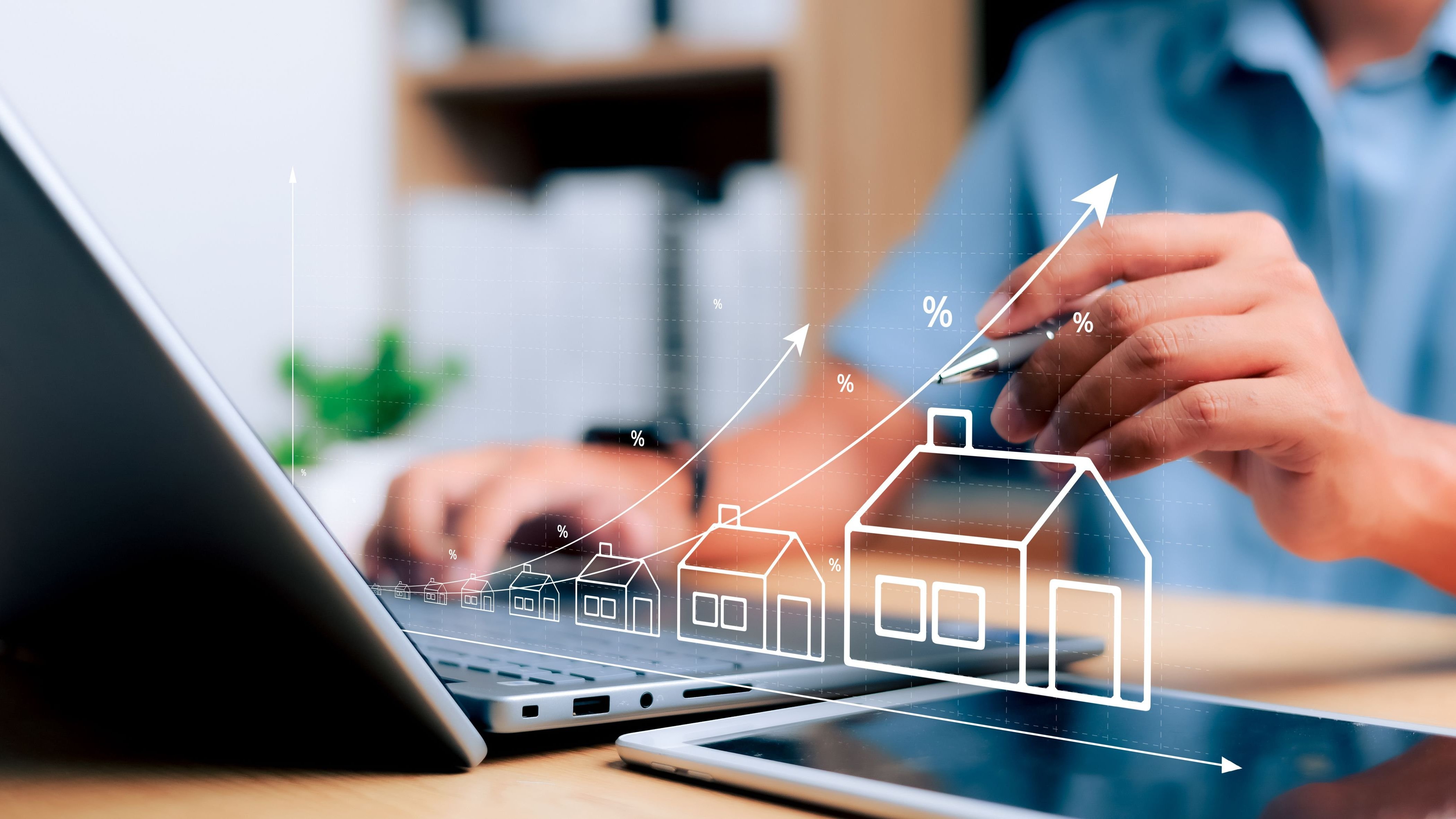 Person on laptop with outlines of houses and upwards arrows.
