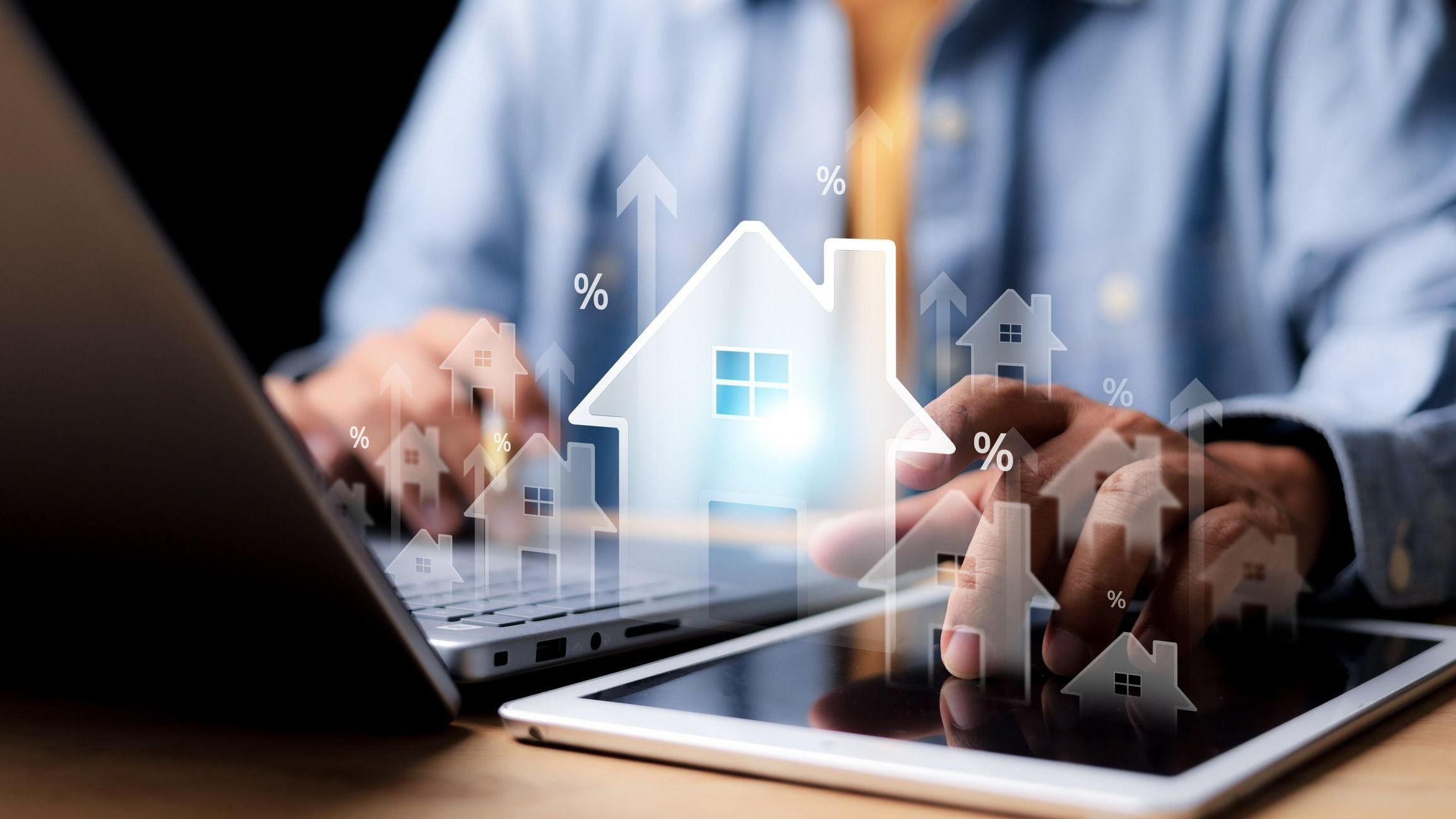 Person on computer and a digital house