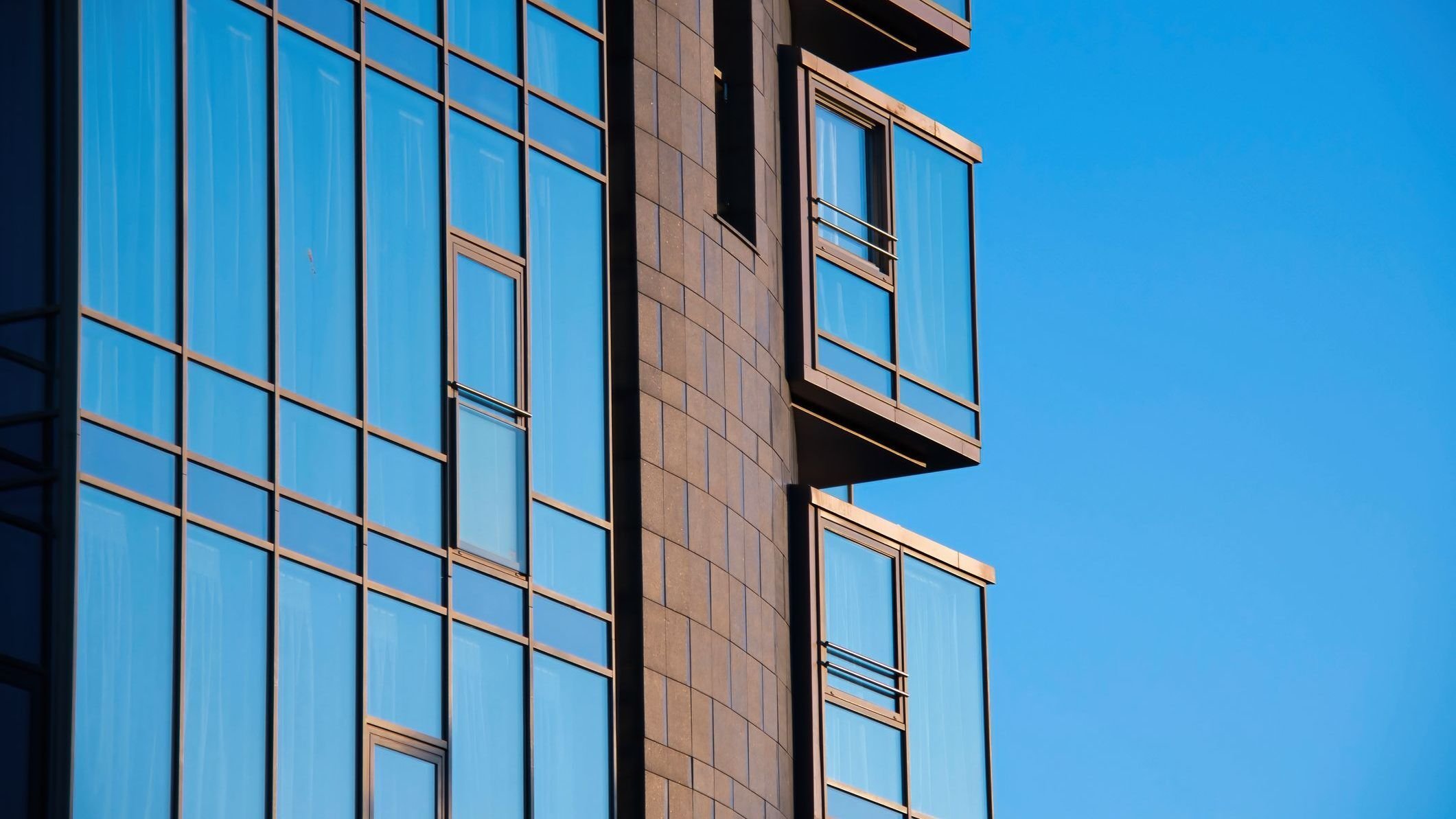 Modern architectural exterior high rise building elegant glass facade.