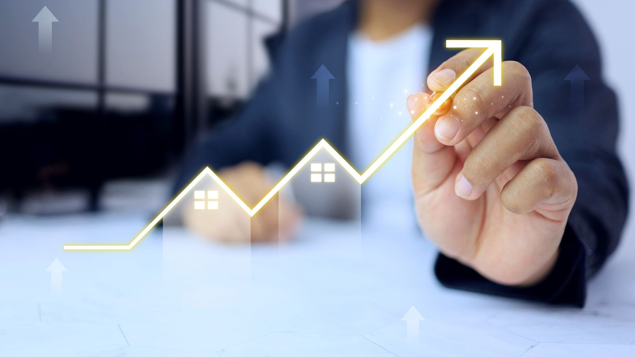Businessman writing a graph to increase upward direction 