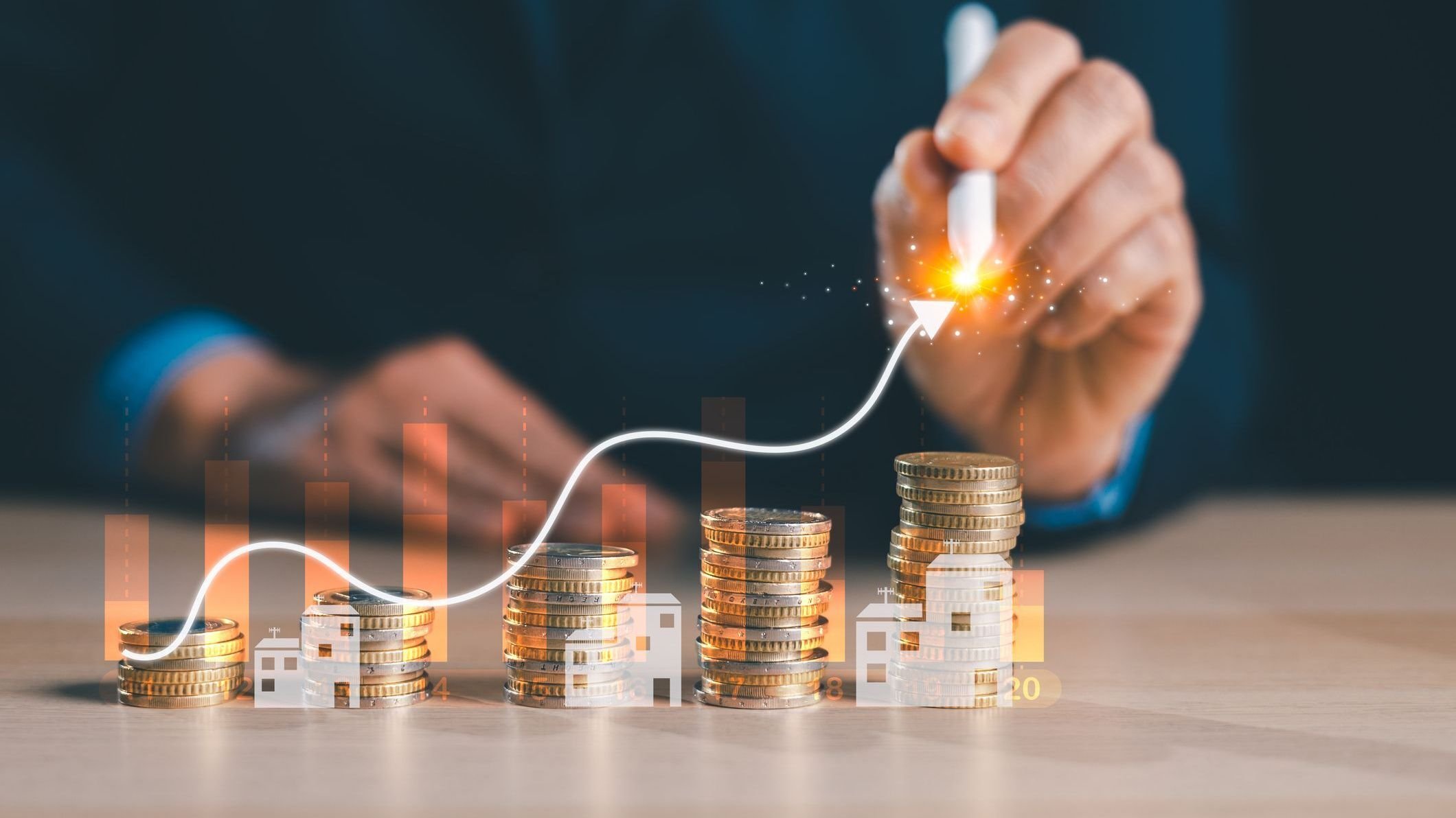 Hand with stylus drawing rising line over stacked coins.