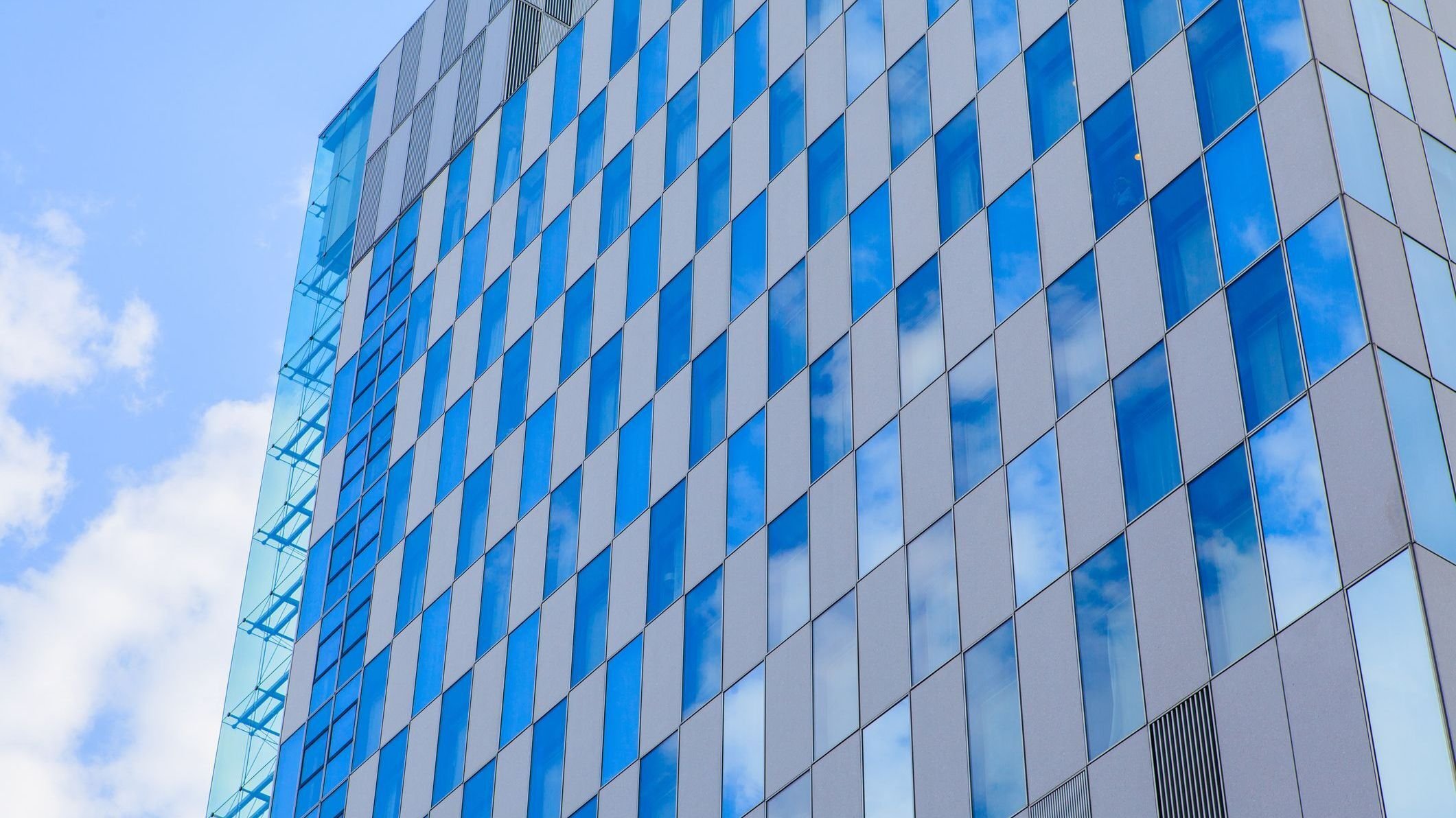 Skyscrapers office building with clouds reflection.