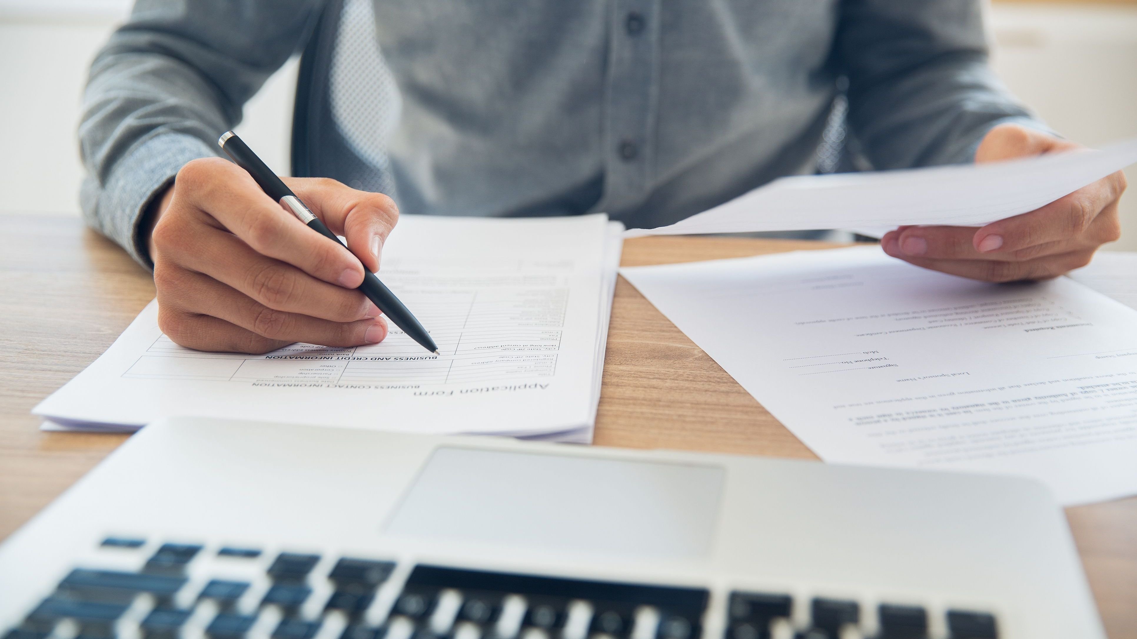 Businessman checking documents at table.
