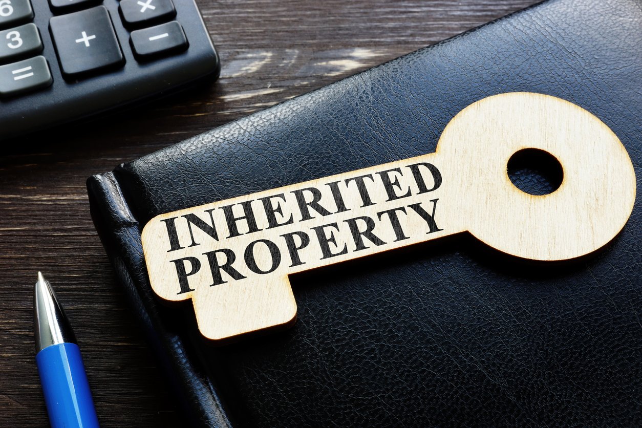 A key saying the word inherited property on top of a portfolio folder