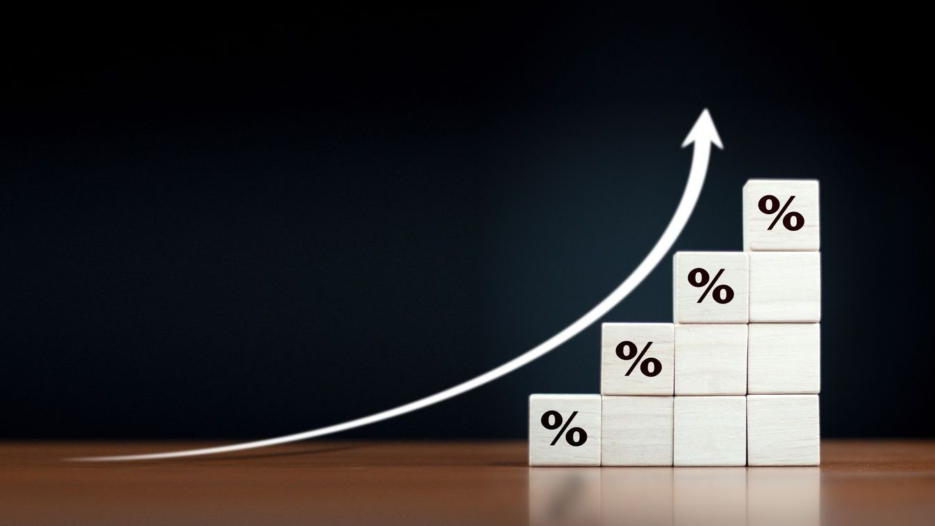 Wooden blocks with Icon percentage symbol and arrow pointing up.