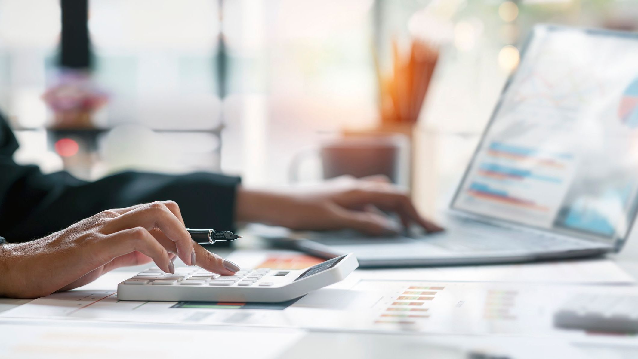 Accountant working Financial investment on calculator, calculate, analyze business and marketing growth on financial document data graph.
