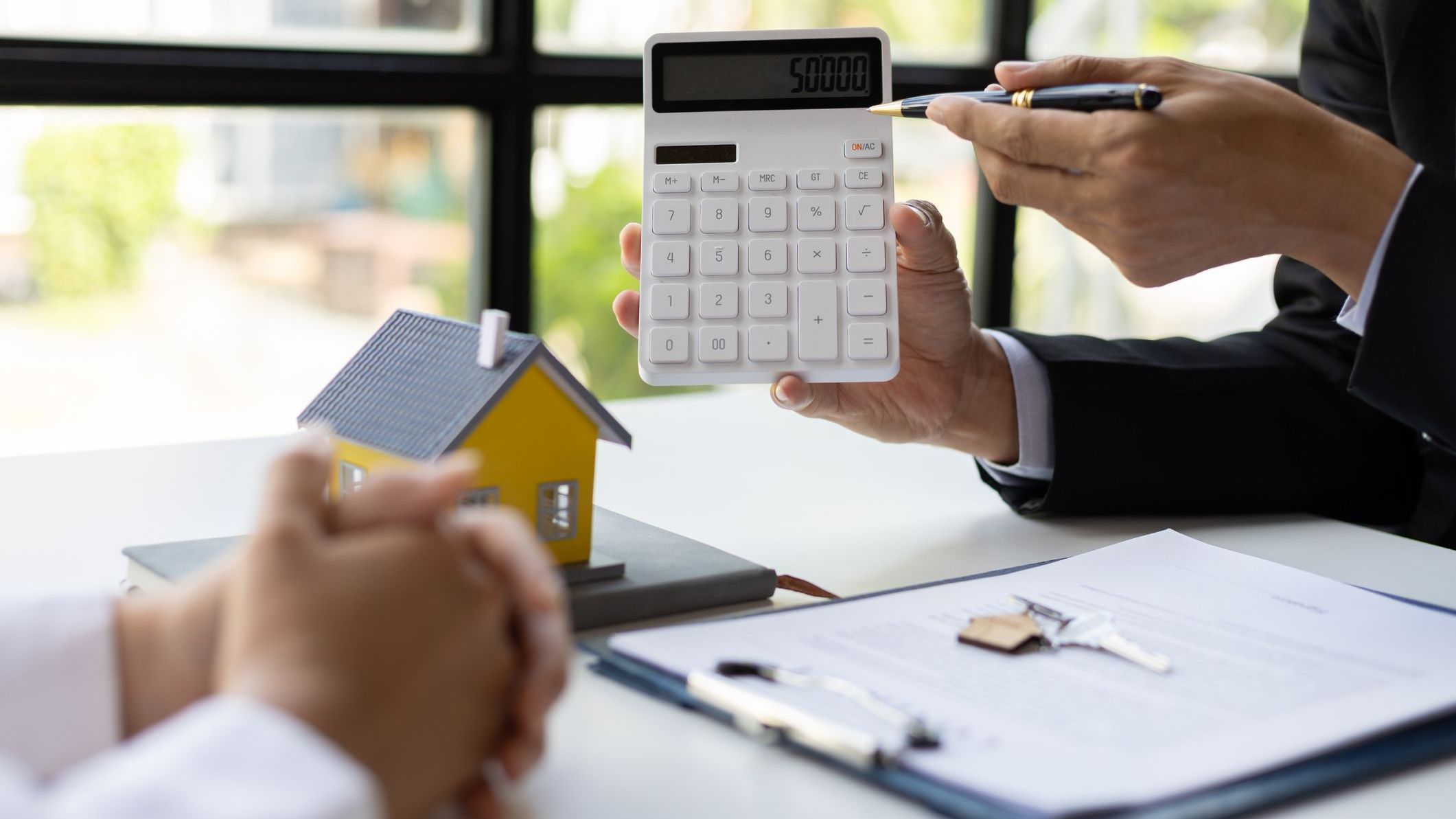 real estate agent discussing the terms of the house purchase agreement contract document and letting the client sign legally