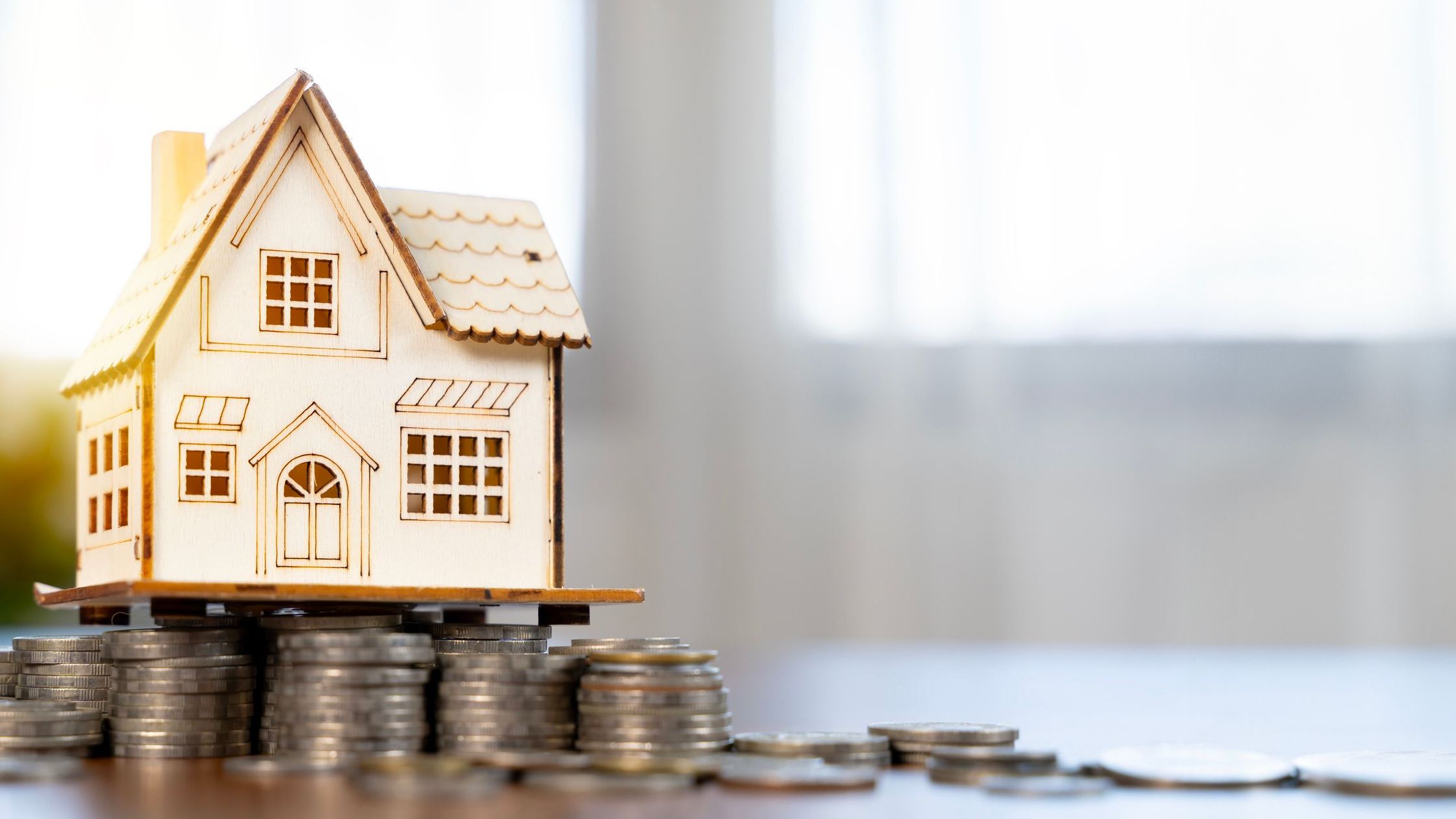 House models on top of coins