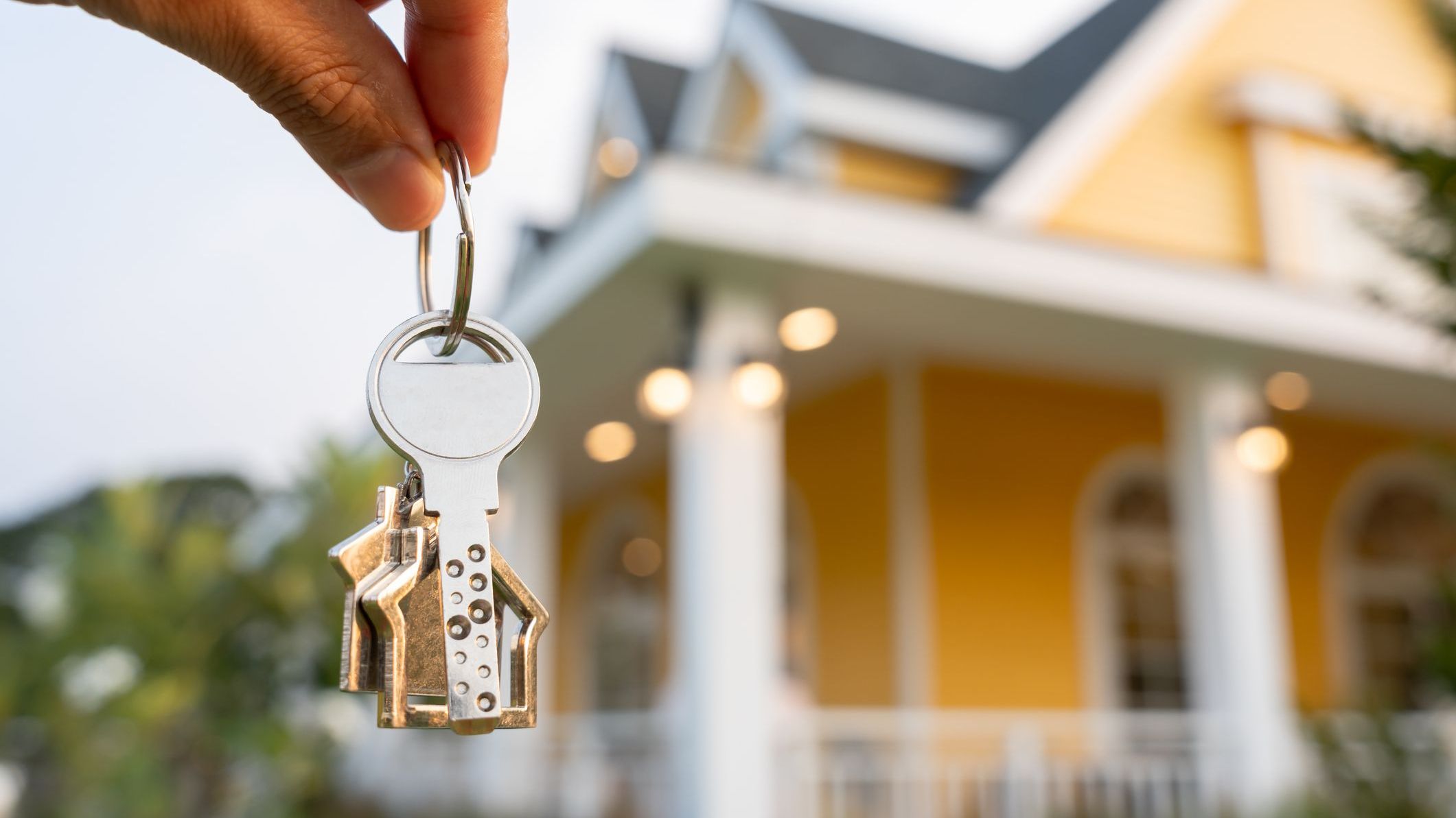 Real estate agent hold key for new house or real estate.